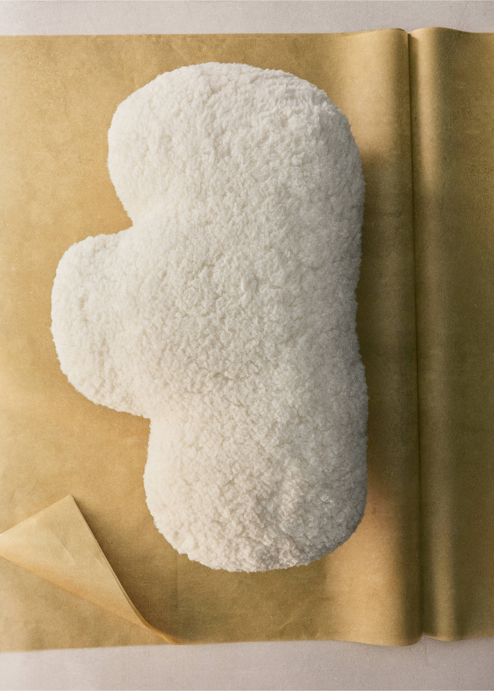 Cream textured faux-shearling cloud cushion on craft paper., Off White. Ref: 37051493-00.