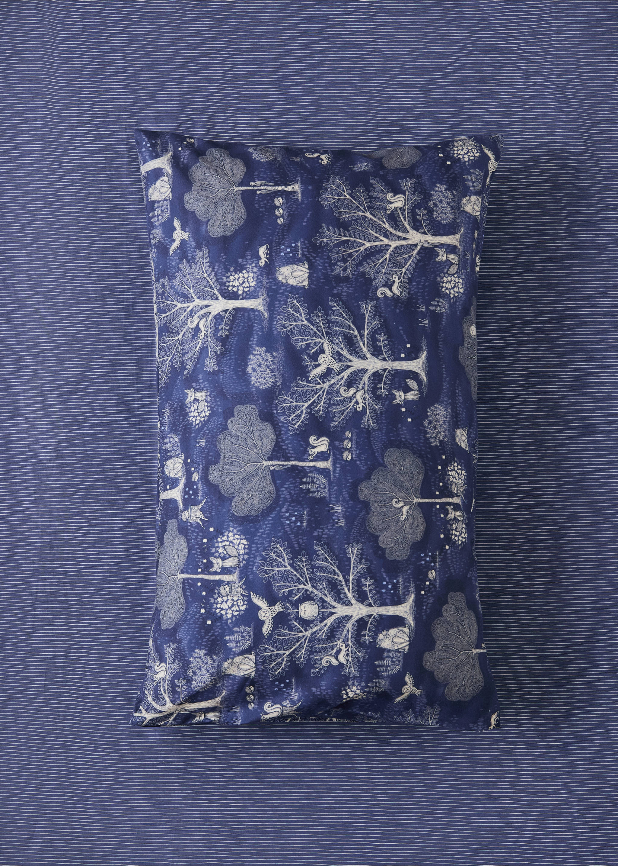 Blue woodland-print cot pillowcase with an intricate animal and tree pattern., Blue. Ref: 37051527-00.