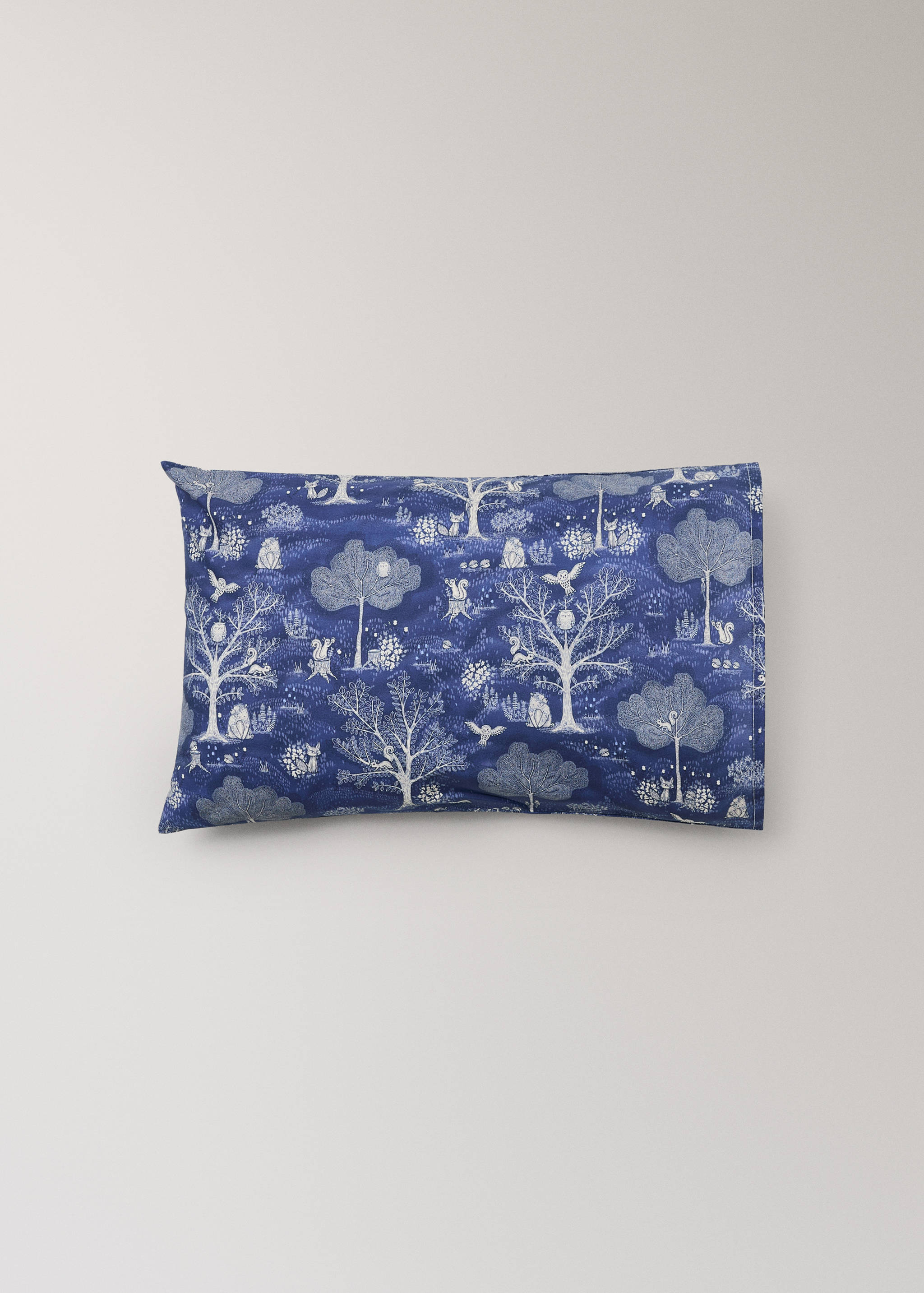 Cot pillowcase with a blue and white woodland animal print.