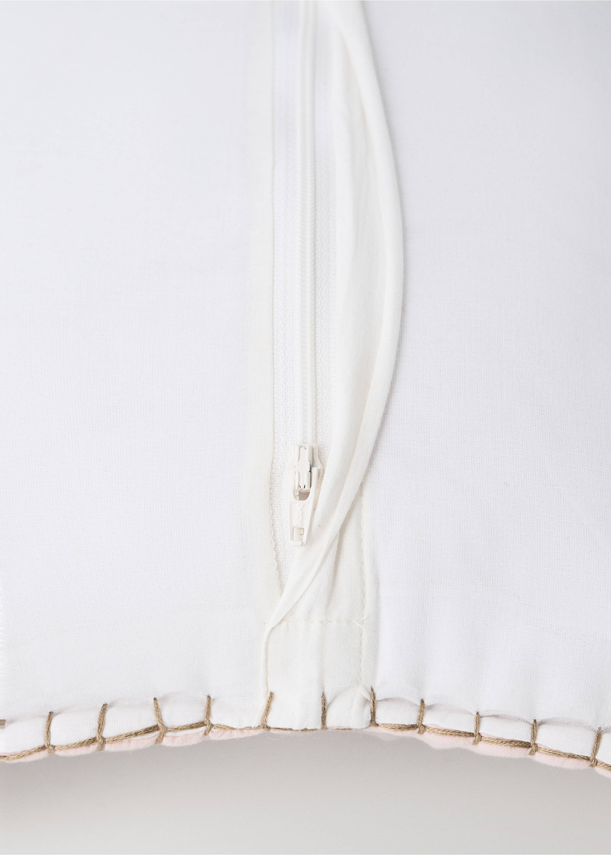 Close-up of a white cushion cover with a zipper and stitching., Nude. Ref: 37051549-00.