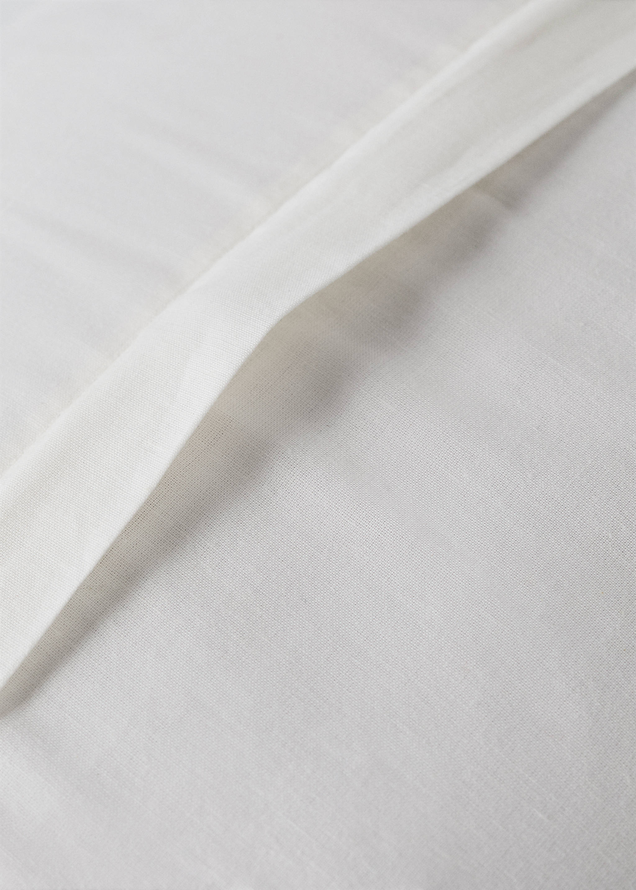 White bed cushion cover detail showing the envelope closure.