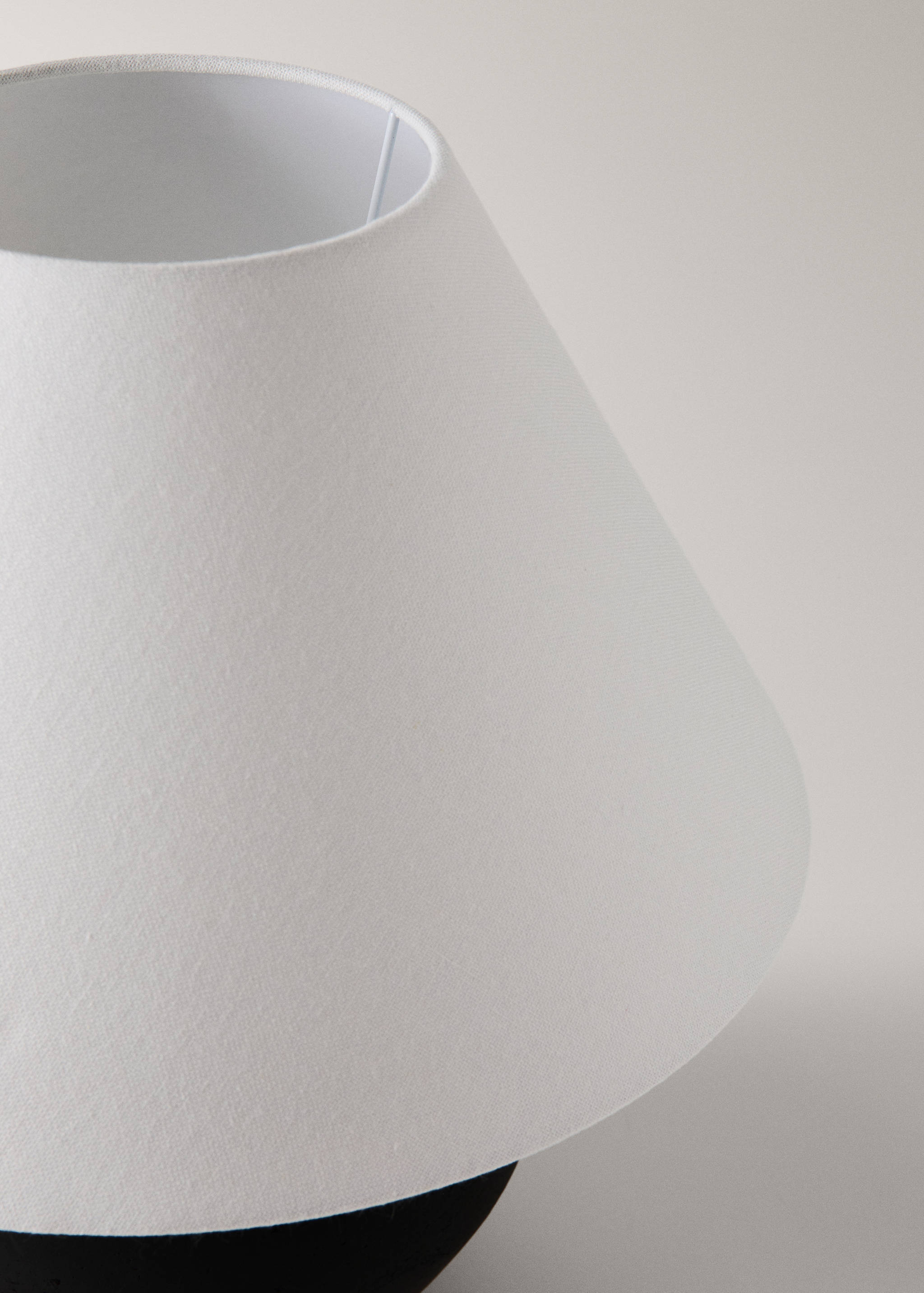 Close-up of a white fabric lamp shade.