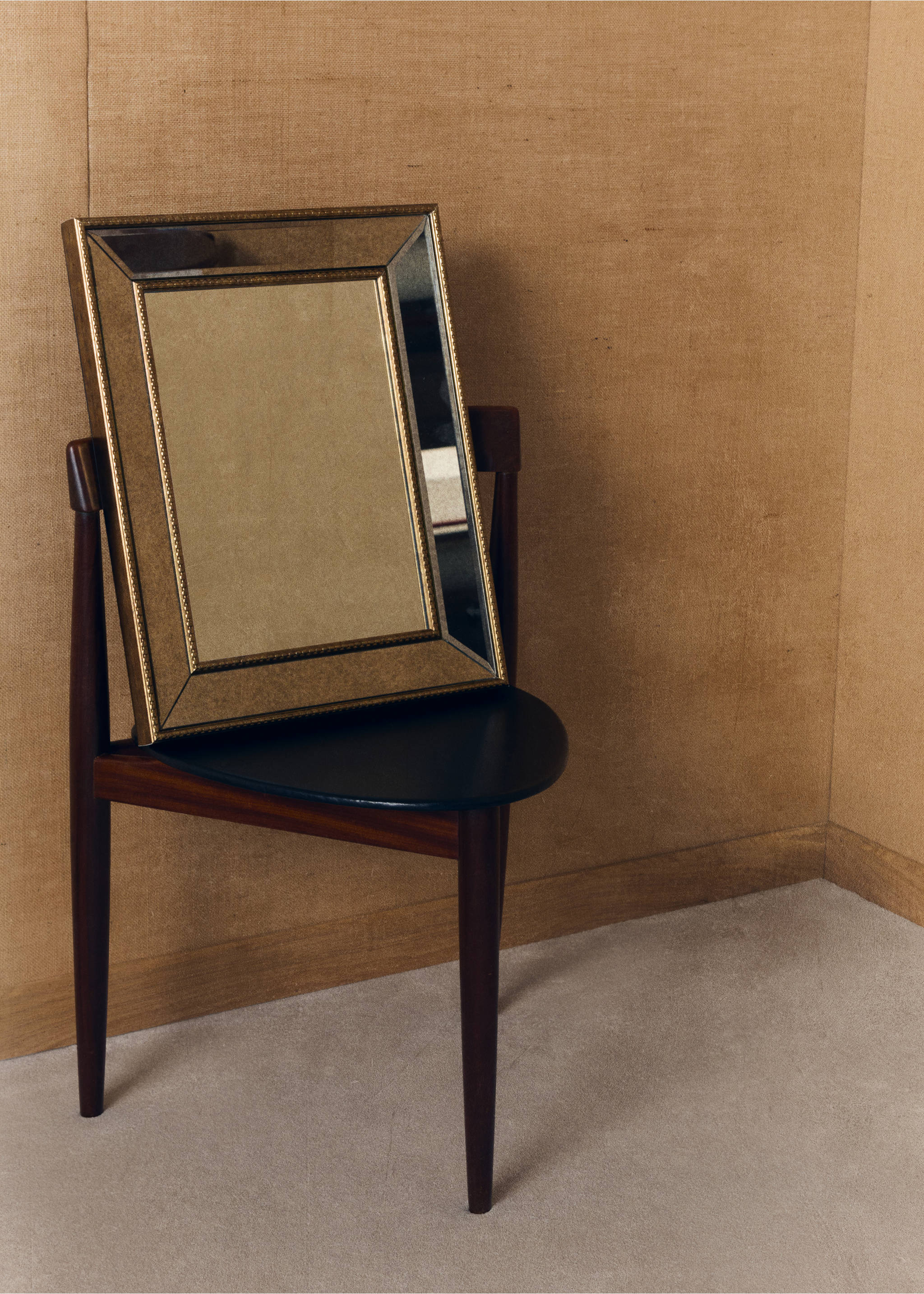 Rectangular mirror with a bevelled metallic frame resting on a dark wood chair., Gold. Ref: 37054081-00.