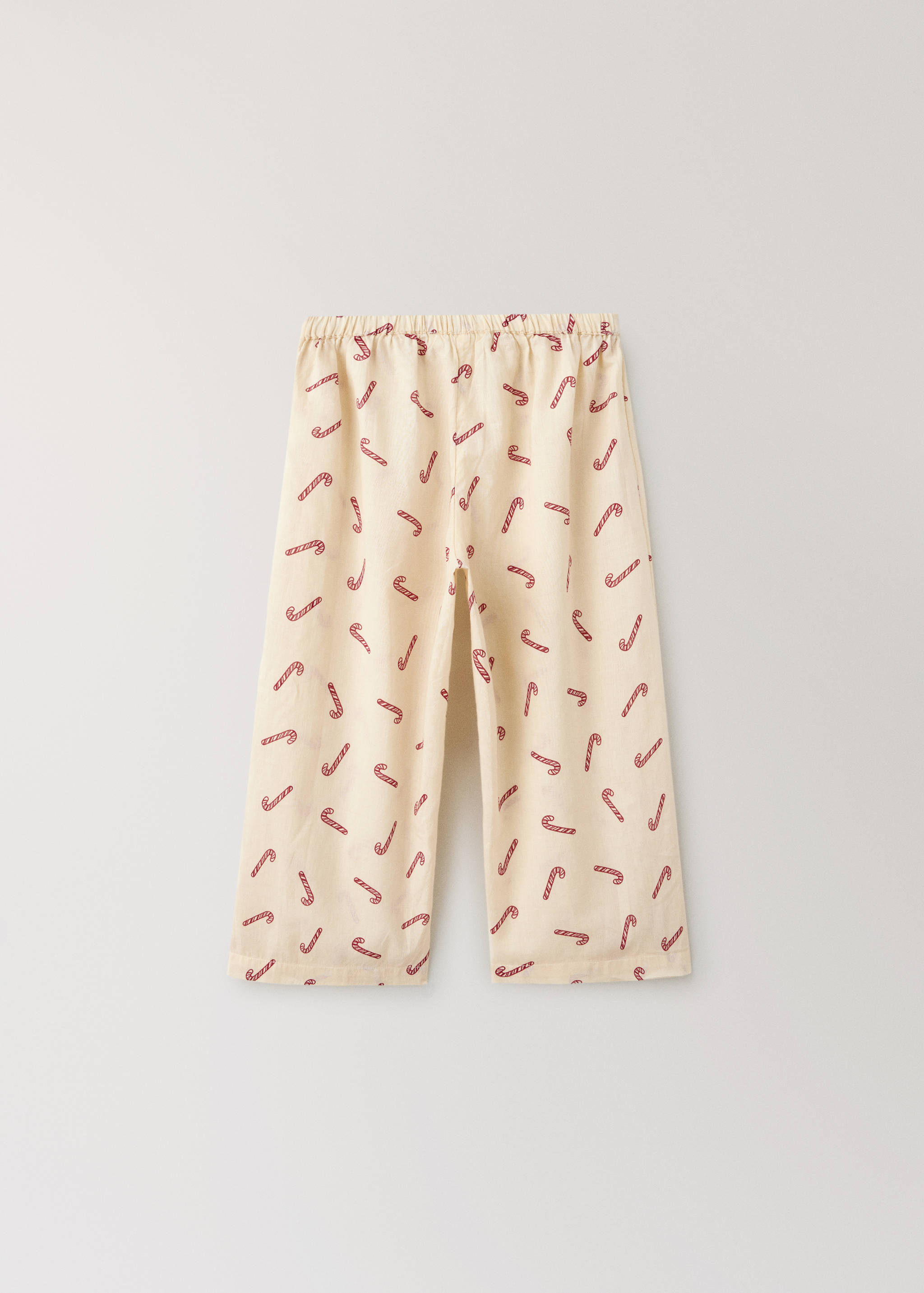 Cream pyjama trousers with a red candy cane print and elasticated waistband.