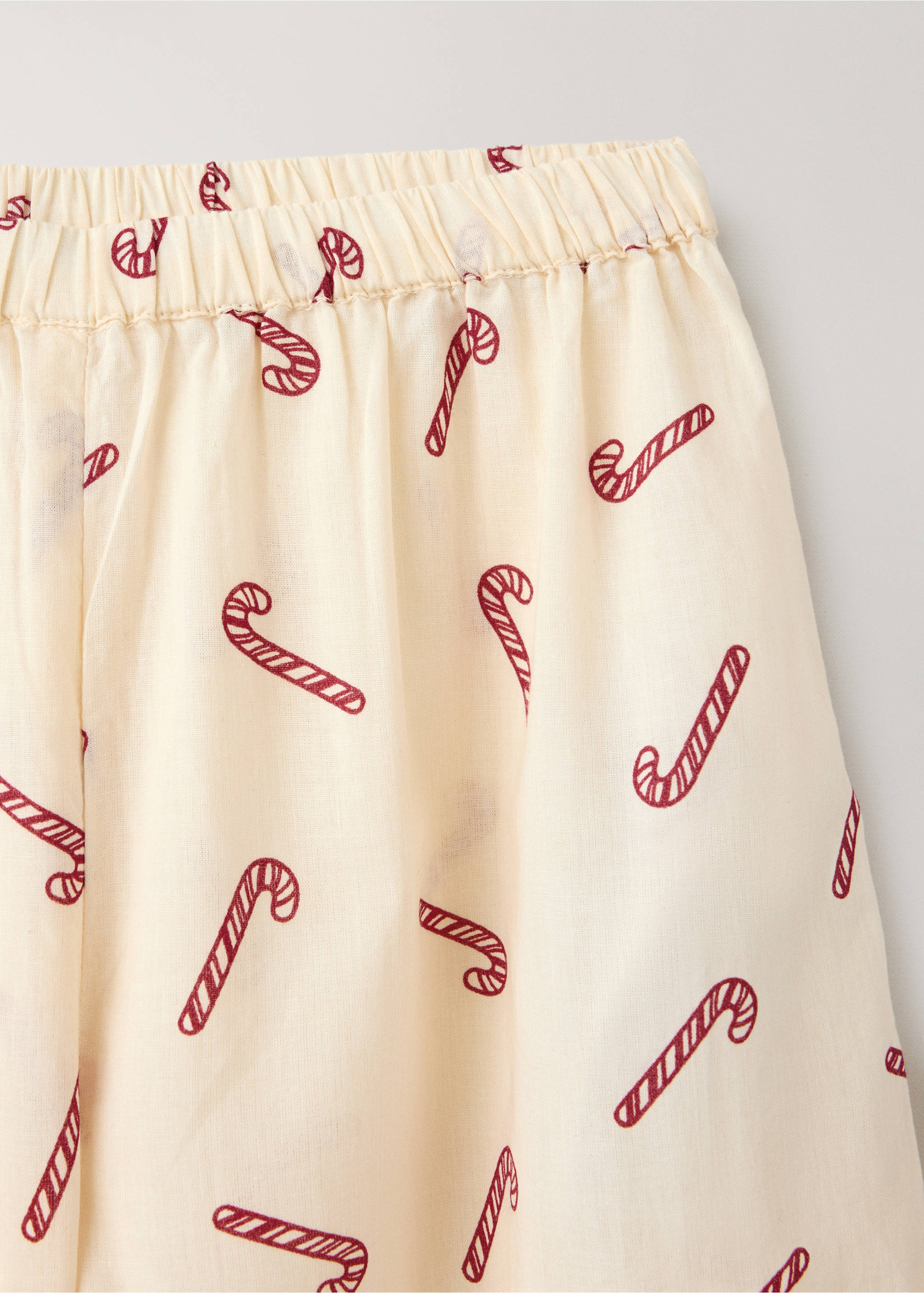 Close-up of cream pyjama trousers with a red candy cane print., Off White. Ref: 37054452-00.
