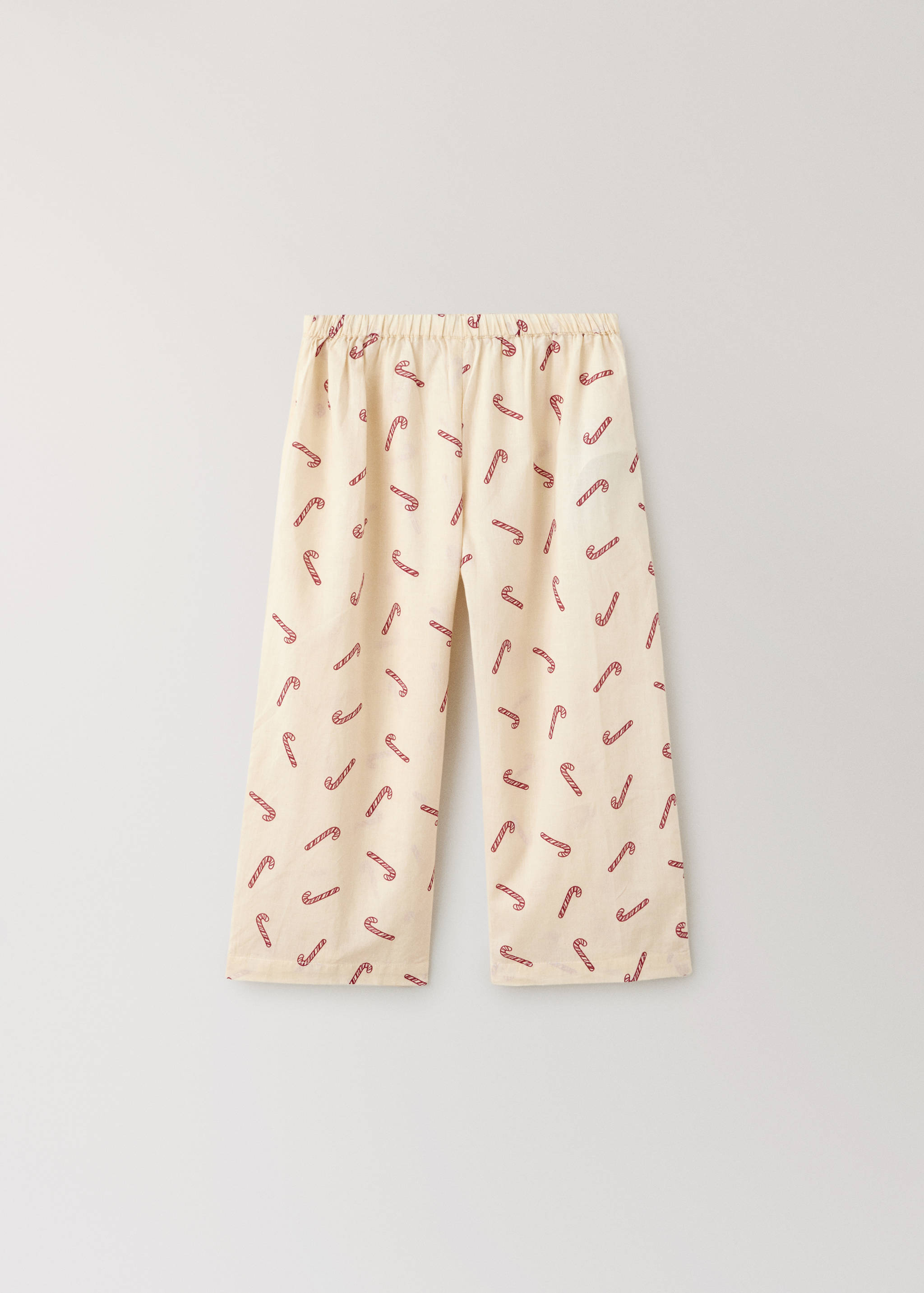 Cream pyjama trousers with a red candy cane print and elastic waistband.