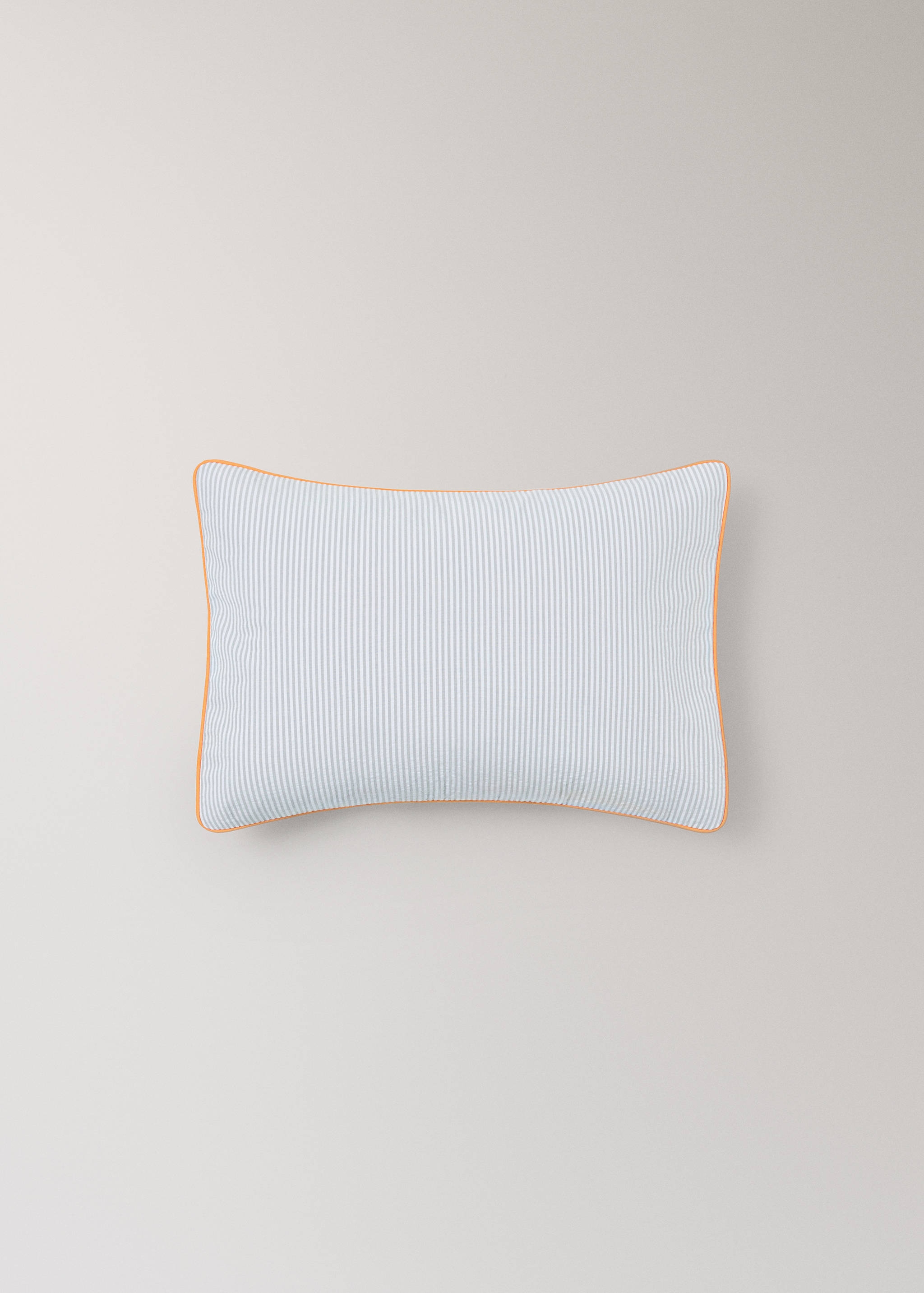 Blue and white striped cushion cover with orange piping.