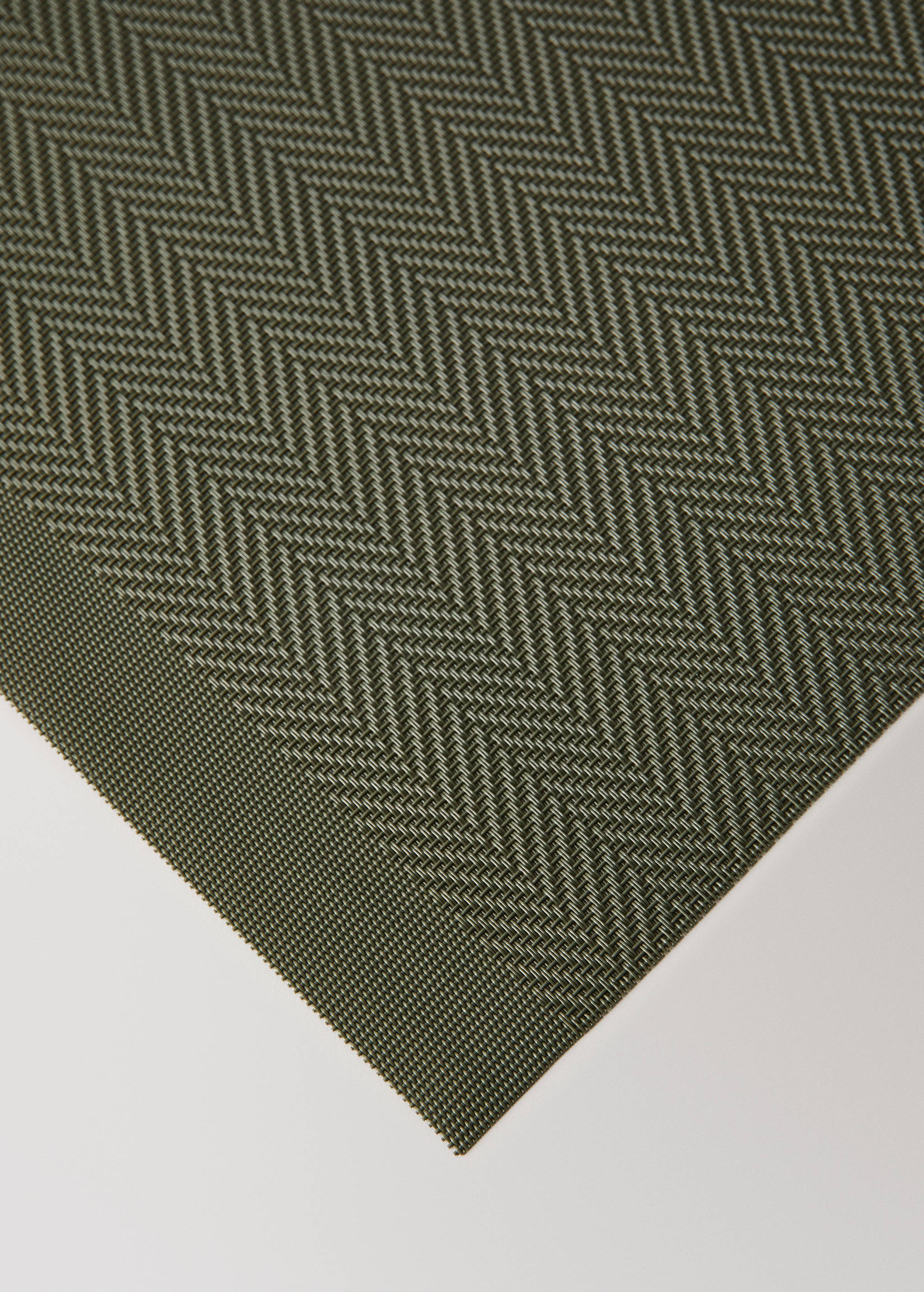 Olive green and cream chevron placemat in textured woven fabric.