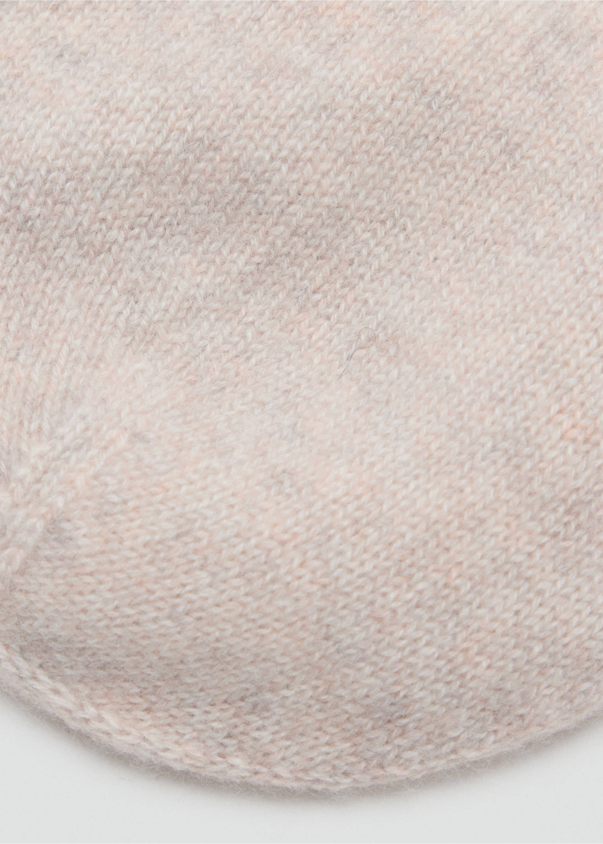 Close-up of a pink knitted beanie showing the soft yarn texture., Sand. Ref: 37054467-00.