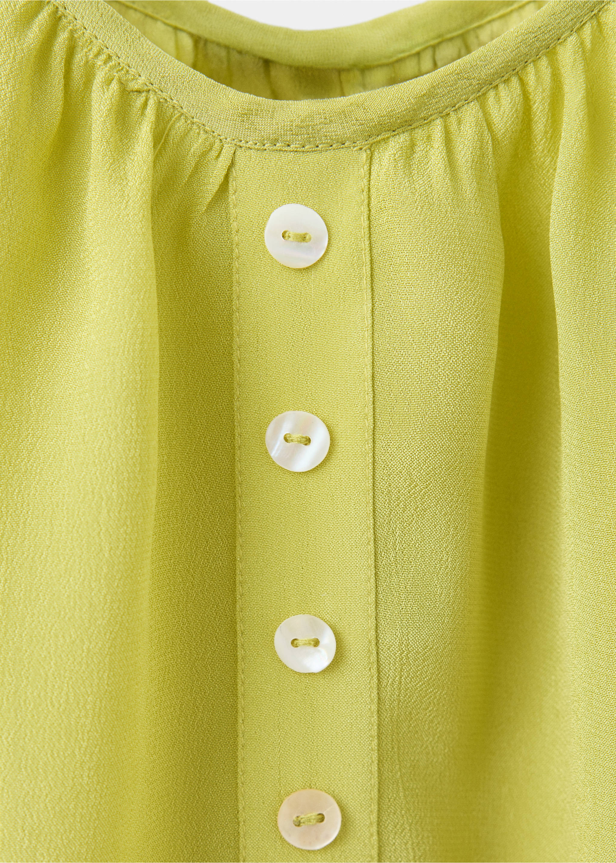 Sleeveless top with decorative buttons - Details of the article 8, Lime. Ref: 37054791-00.