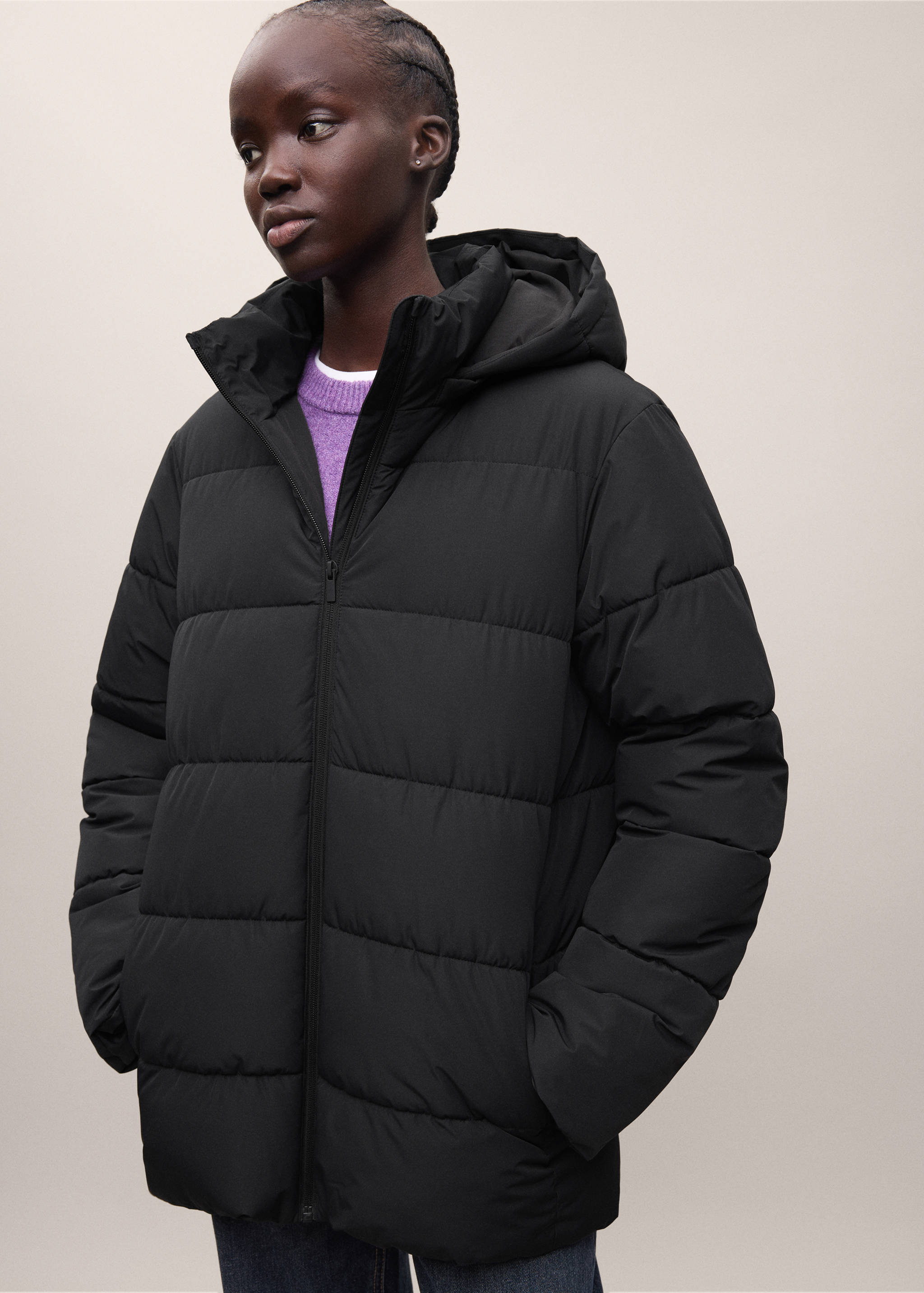 Black hooded padded anorak with a front zip and horizontal quilting.