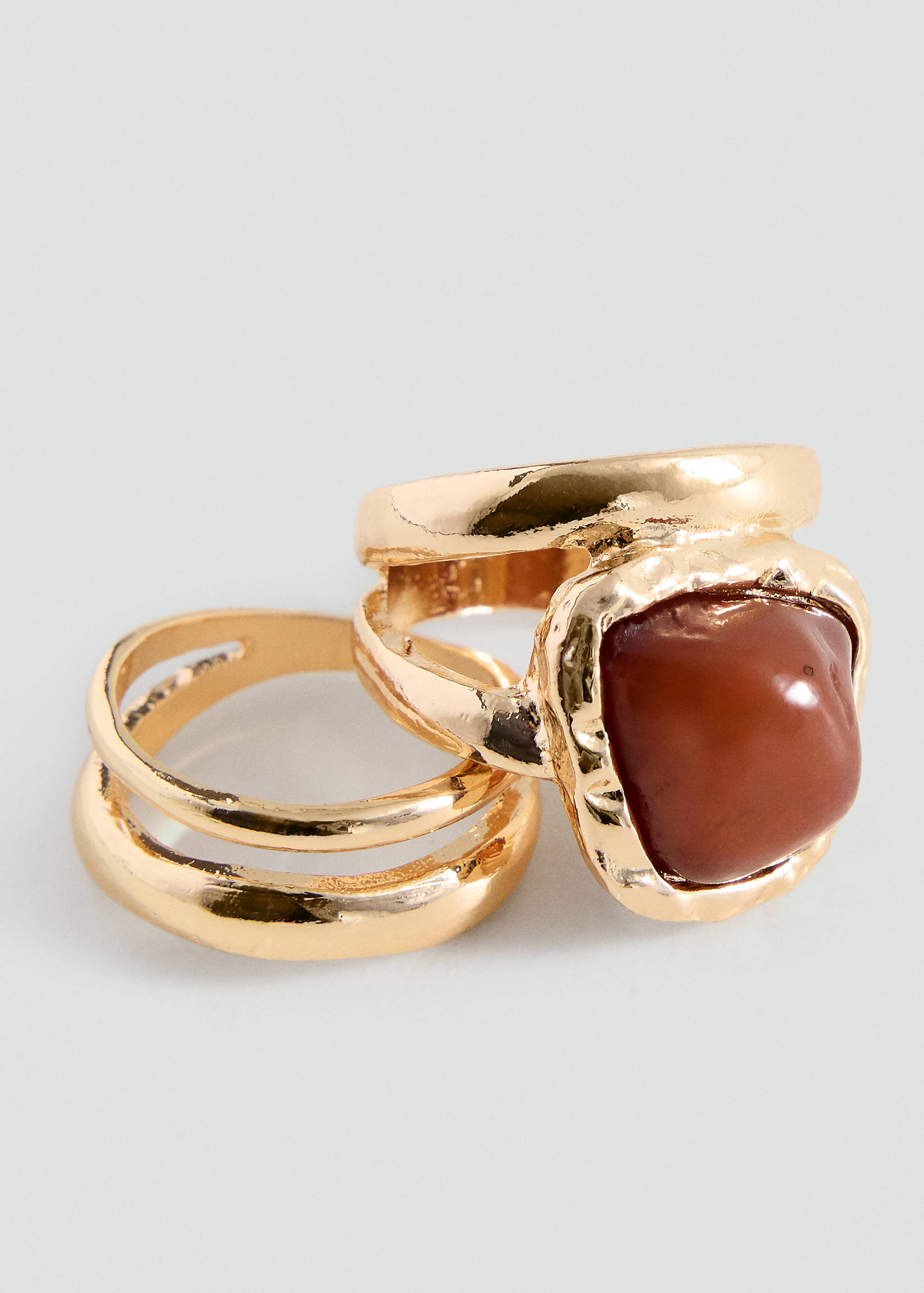 Gold-coloured ring set with a square brown stone and a dual-band design.