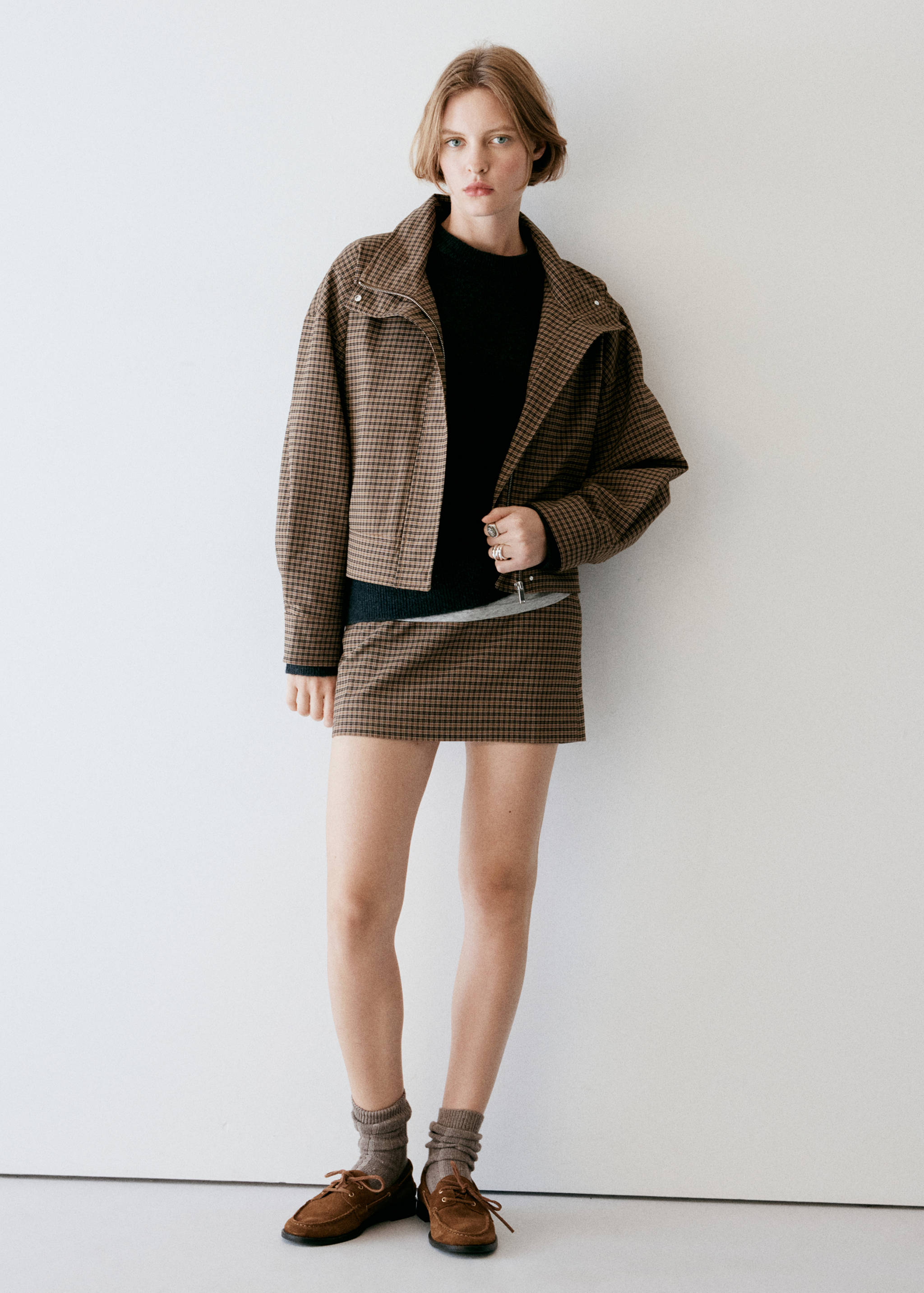Brown houndstooth jacket in a cropped, collared silhouette.