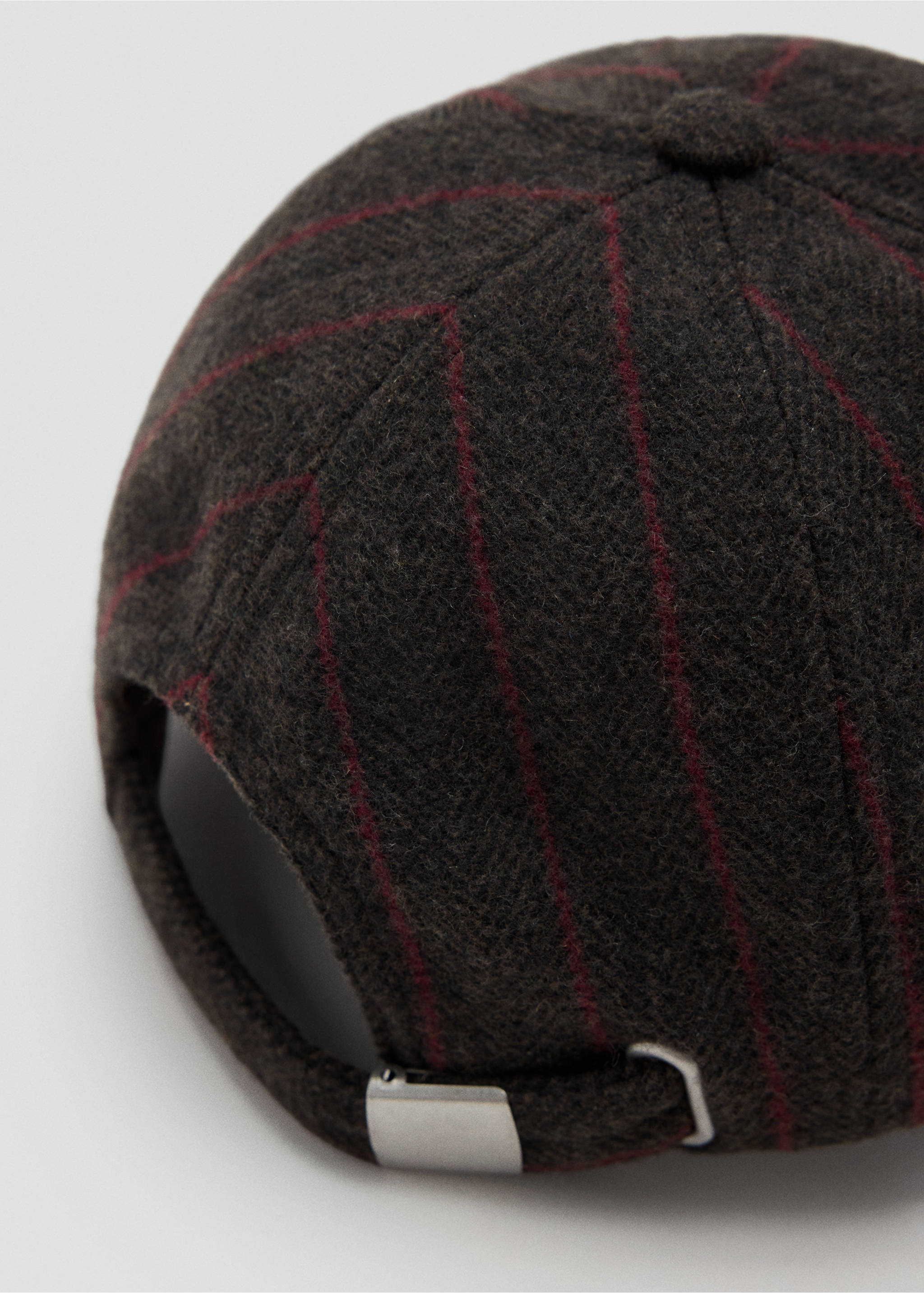 Close-up of a dark brown pinstriped cap with an adjustable silver metal buckle., Brown. Ref: 37056013-00.