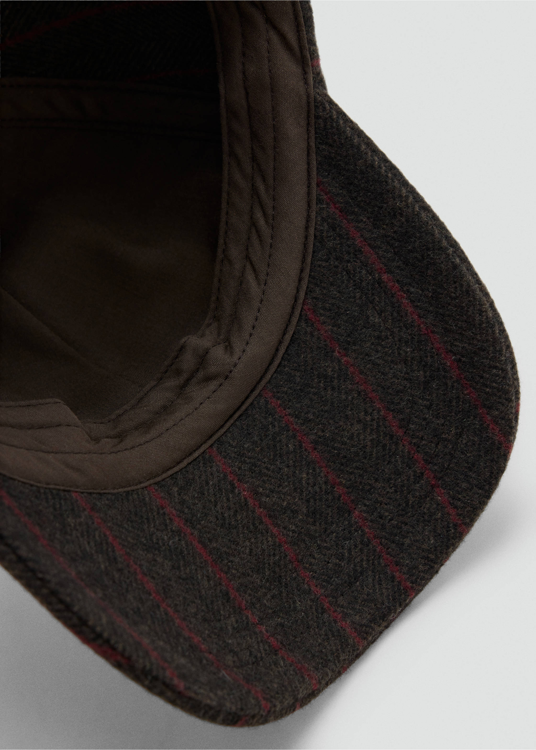 Close-up of a dark brown pinstripe cap showing the inner lining and brim., Brown. Ref: 37056013-00.