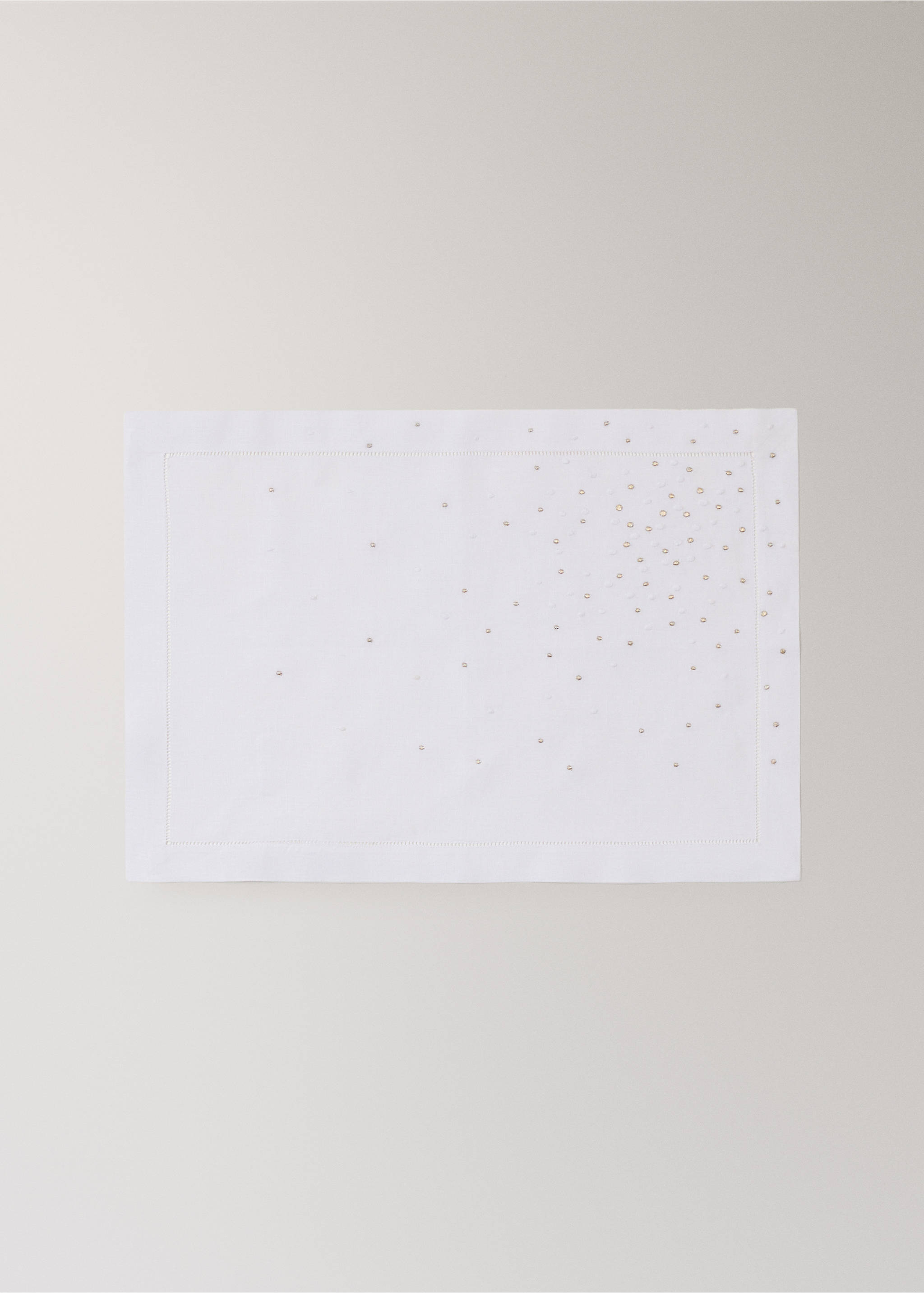 White rectangular placemat with a stitched border and scattered metallic beads., White. Ref: 37056333-00.