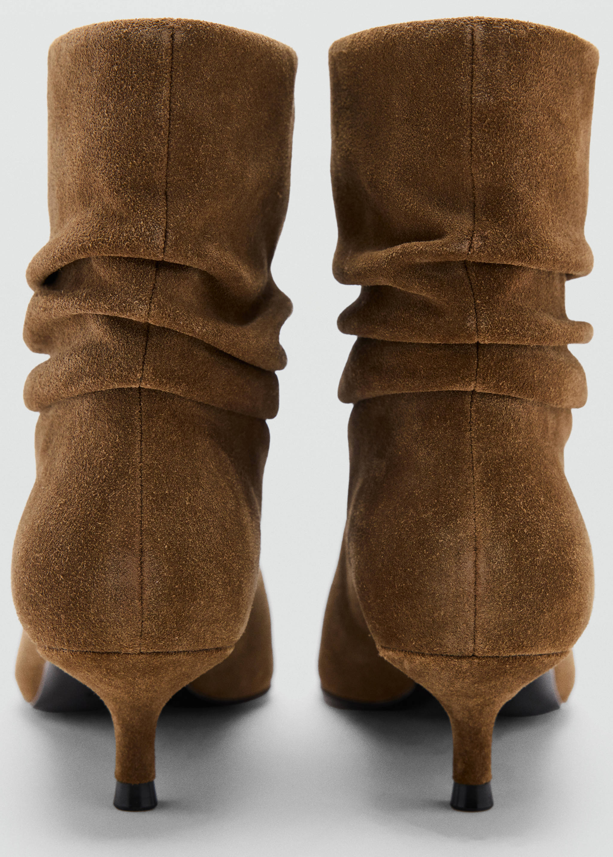 Brown suede ankle boots with a slouchy shaft and kitten heels.