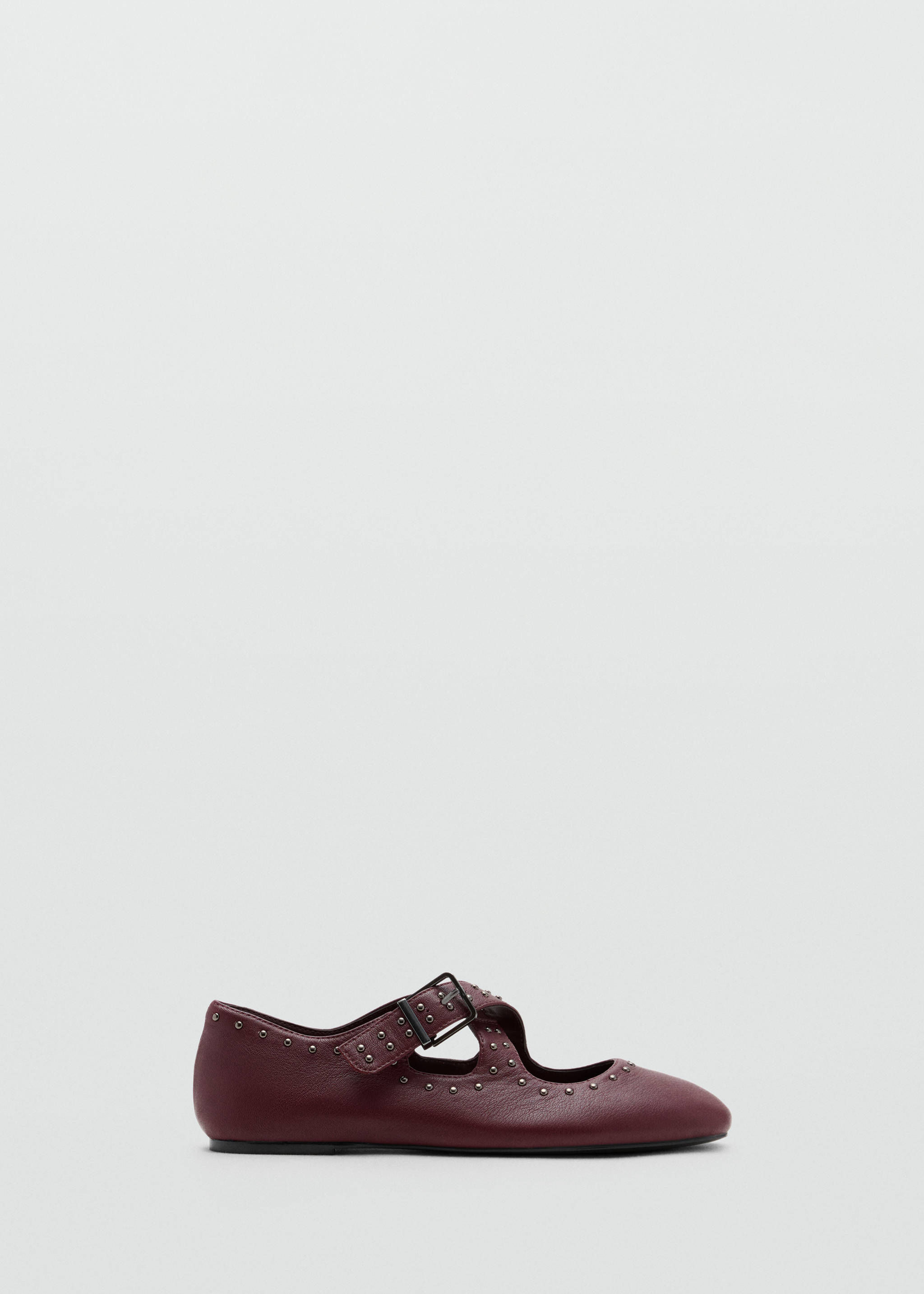 Burgundy flat shoe with studded straps and buckle.
