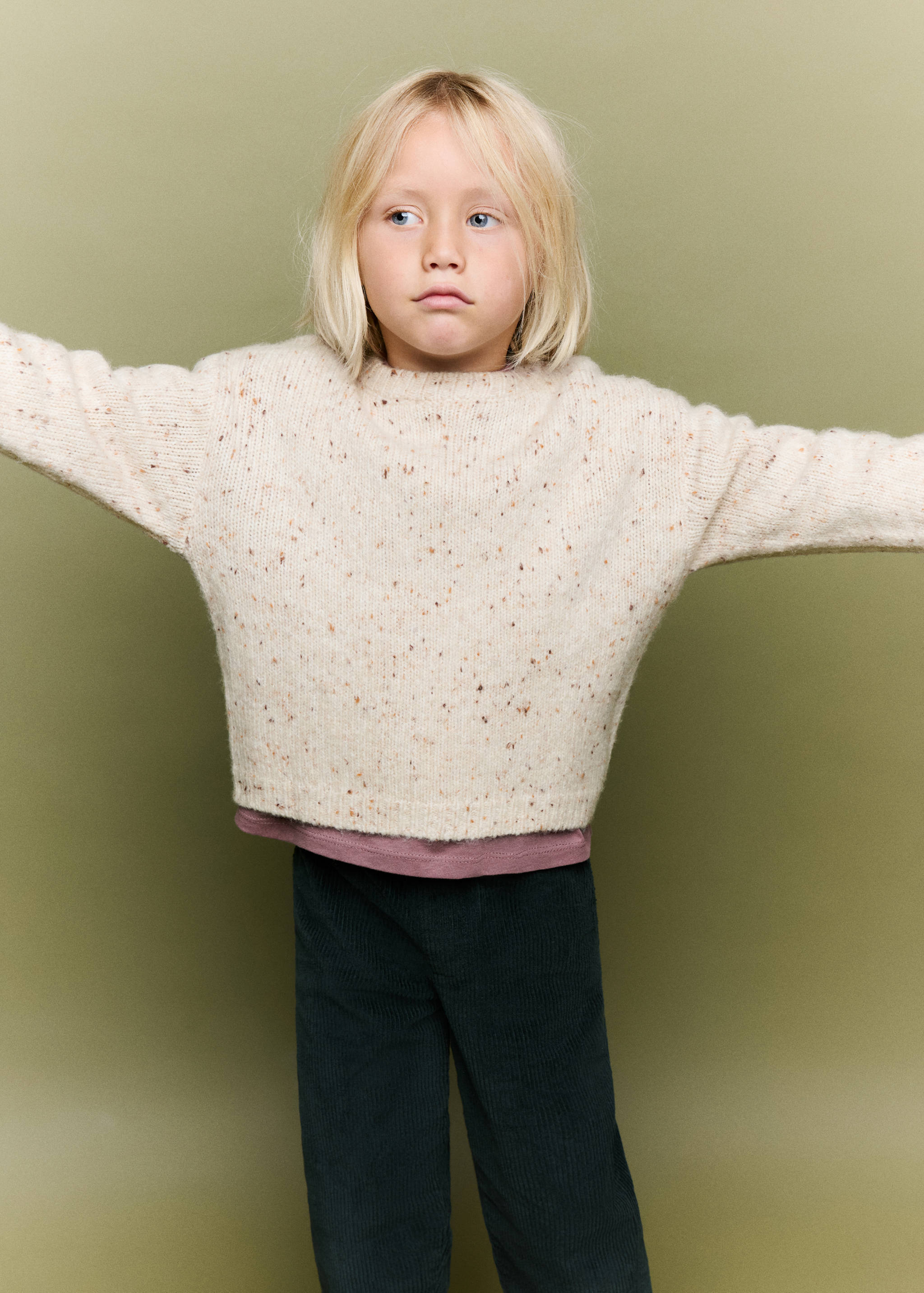 Cream speckled knit sweater with long sleeves and a crew neck.