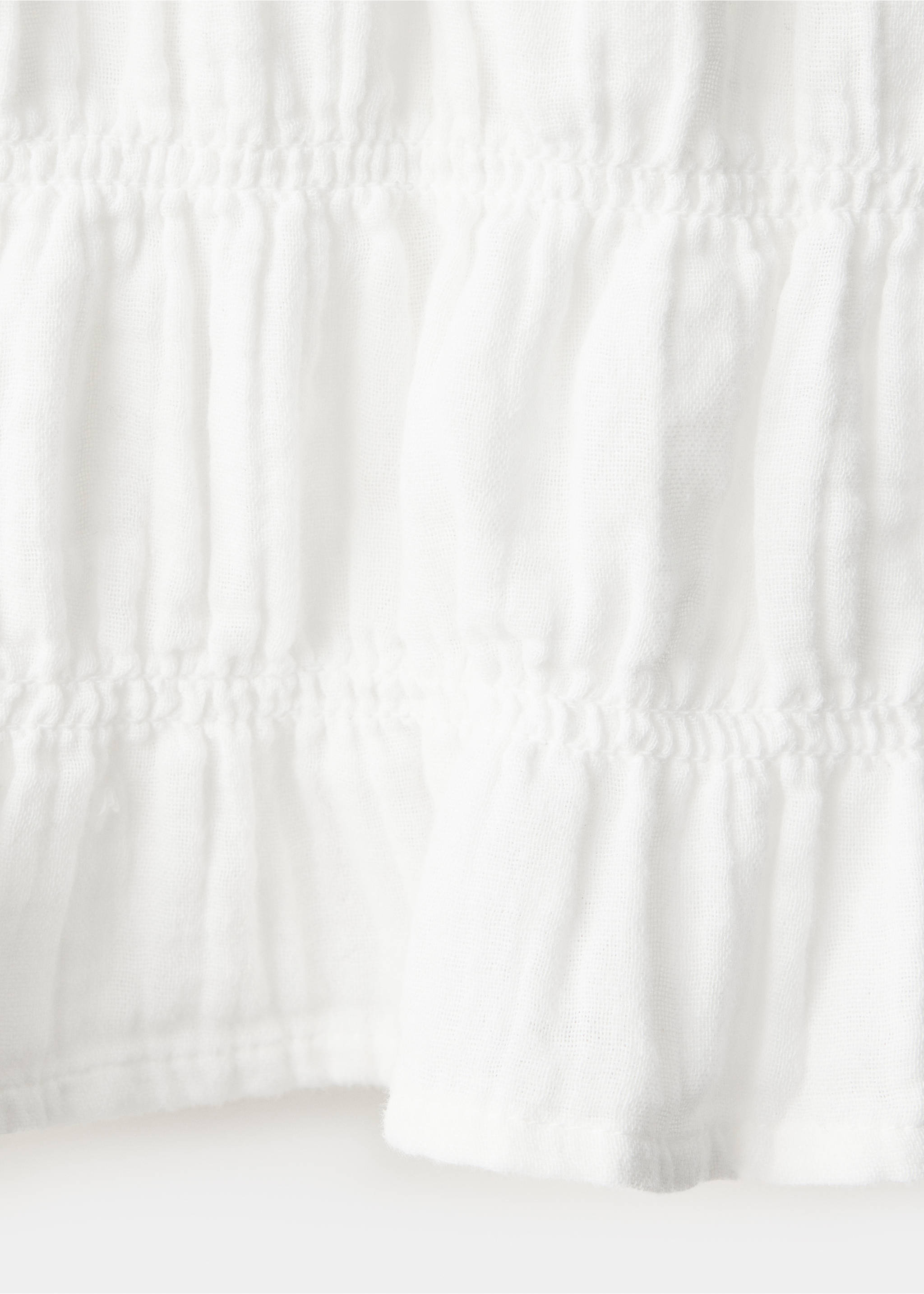 Close-up of white textured shirt fabric with smocked ruffles., White. Ref: 37057136-00.