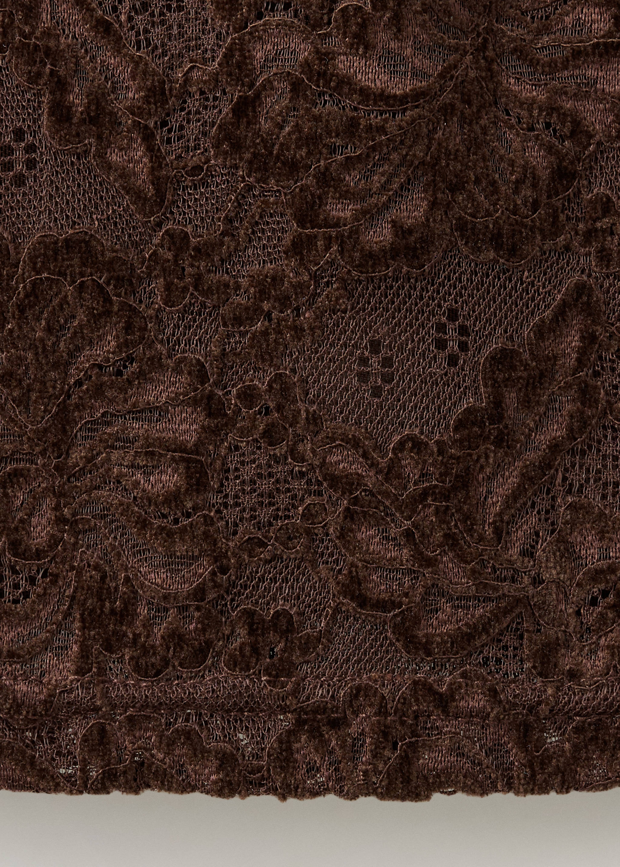 Close-up of the dark brown lace top fabric detail.