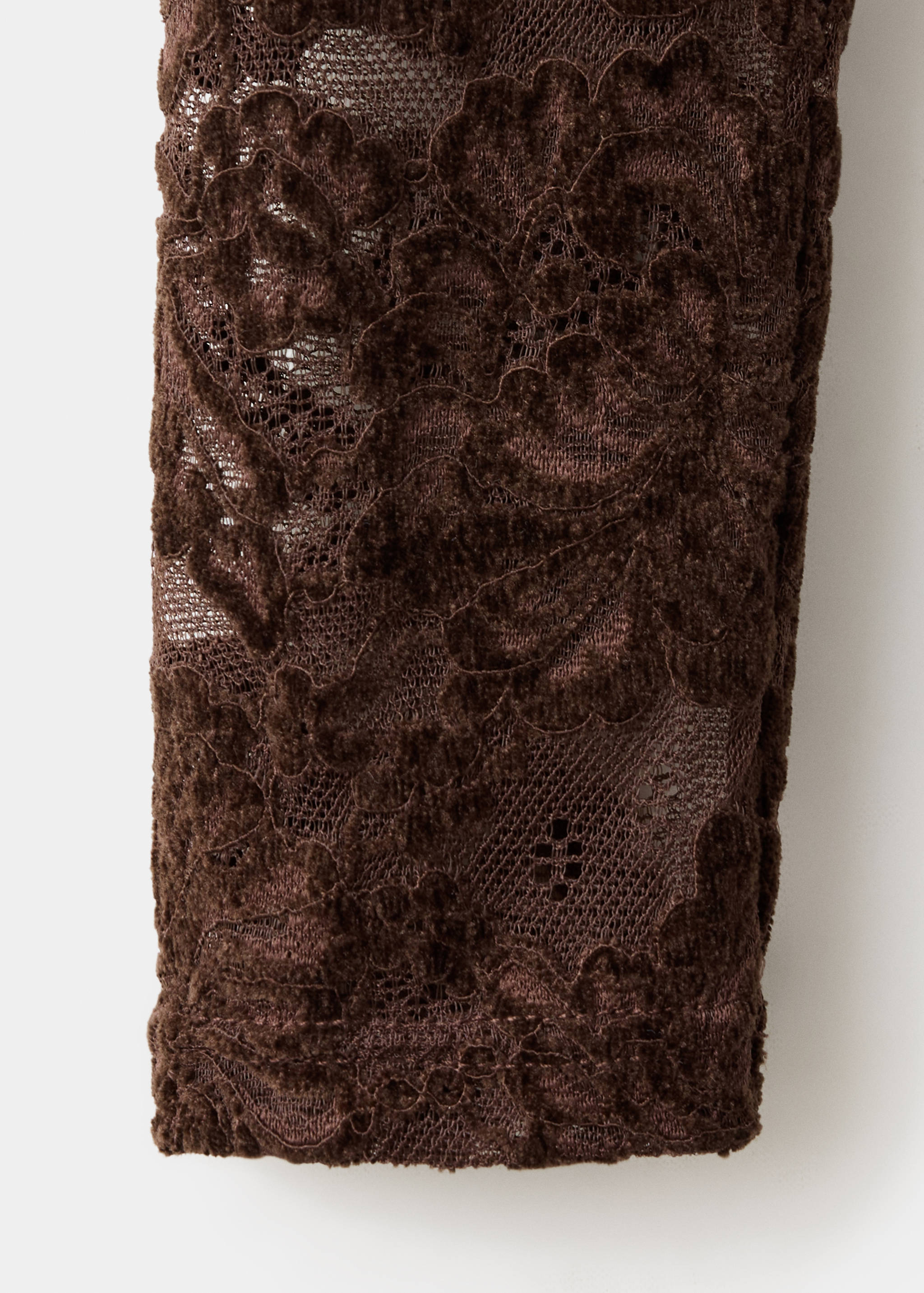 Brown lace fabric detail of a top.