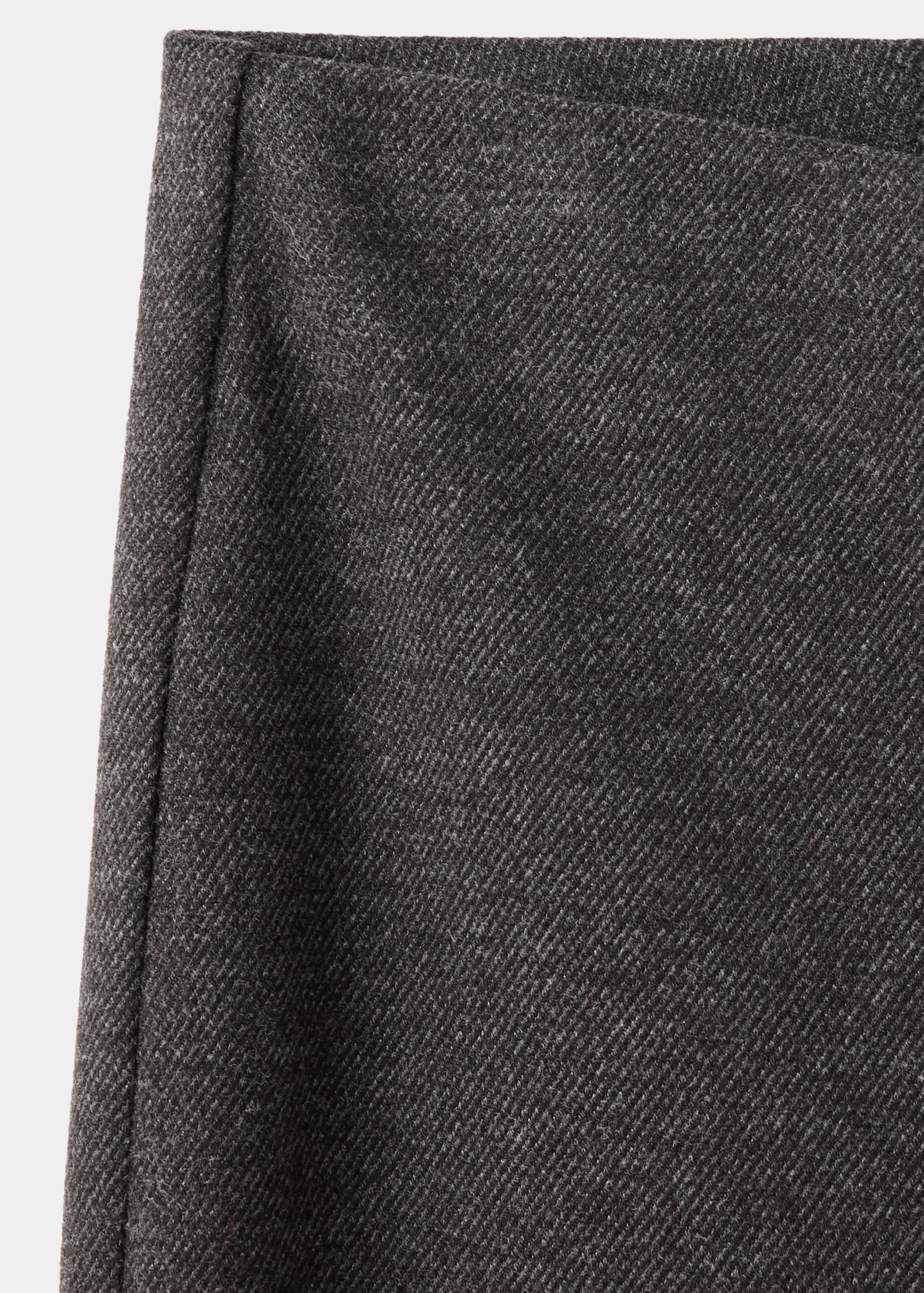 Close-up of grey trousers with a textured twill weave.