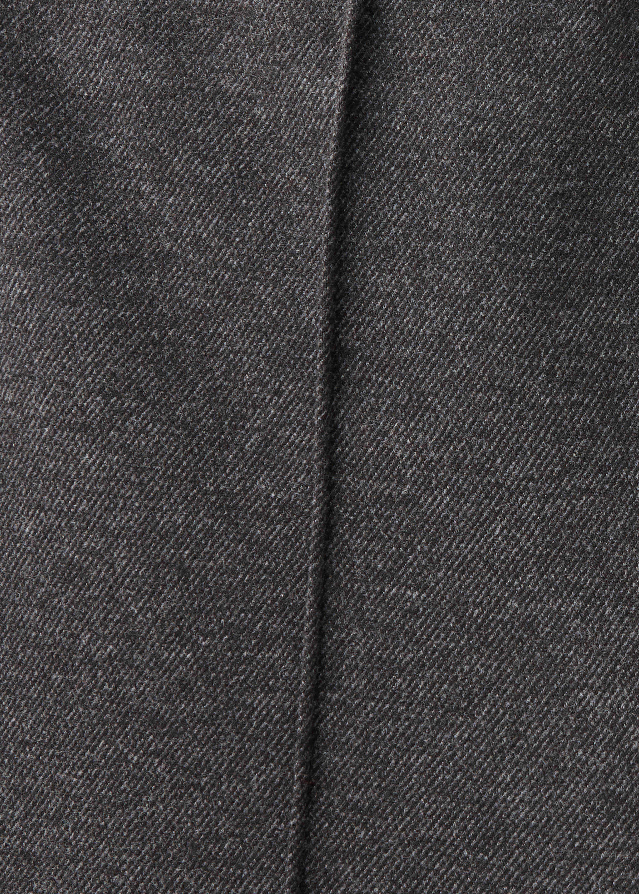 Close-up of dark grey twill trousers fabric texture.