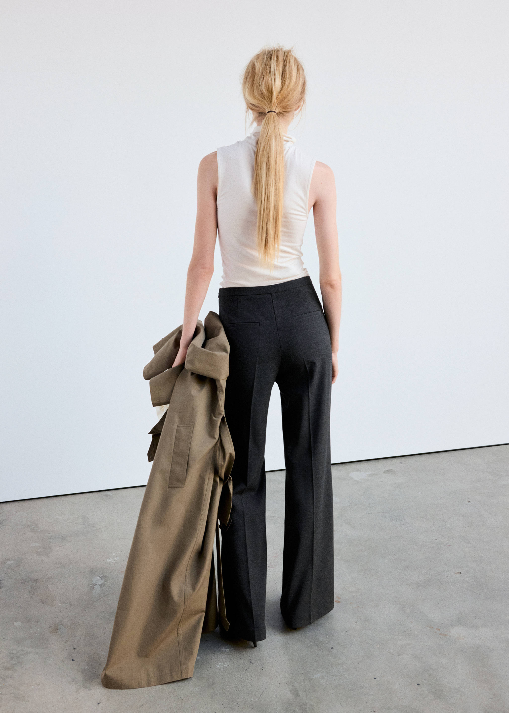 Dark grey trousers with back pockets, viewed from behind.