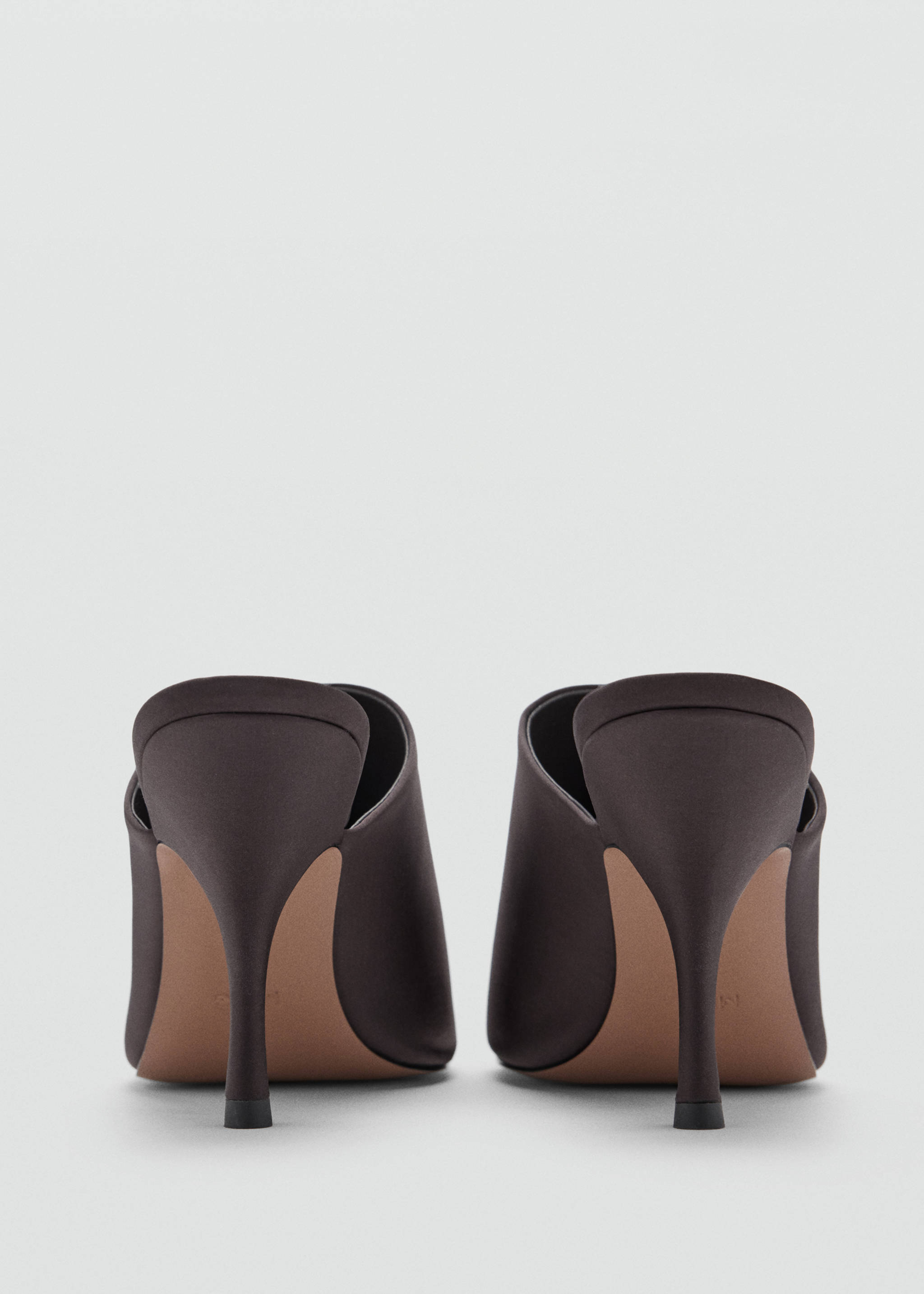 Close-up of dark brown satin high-heeled sandals from the back view.