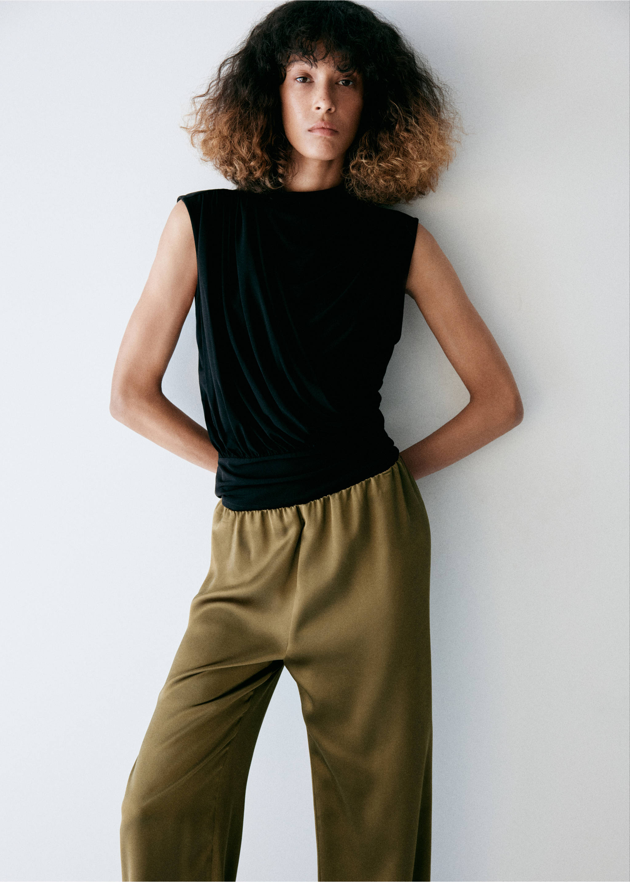 Olive green satin trousers with an elasticated waist, paired with a black sleeveless top., Khaki. Ref: 37057805-00.