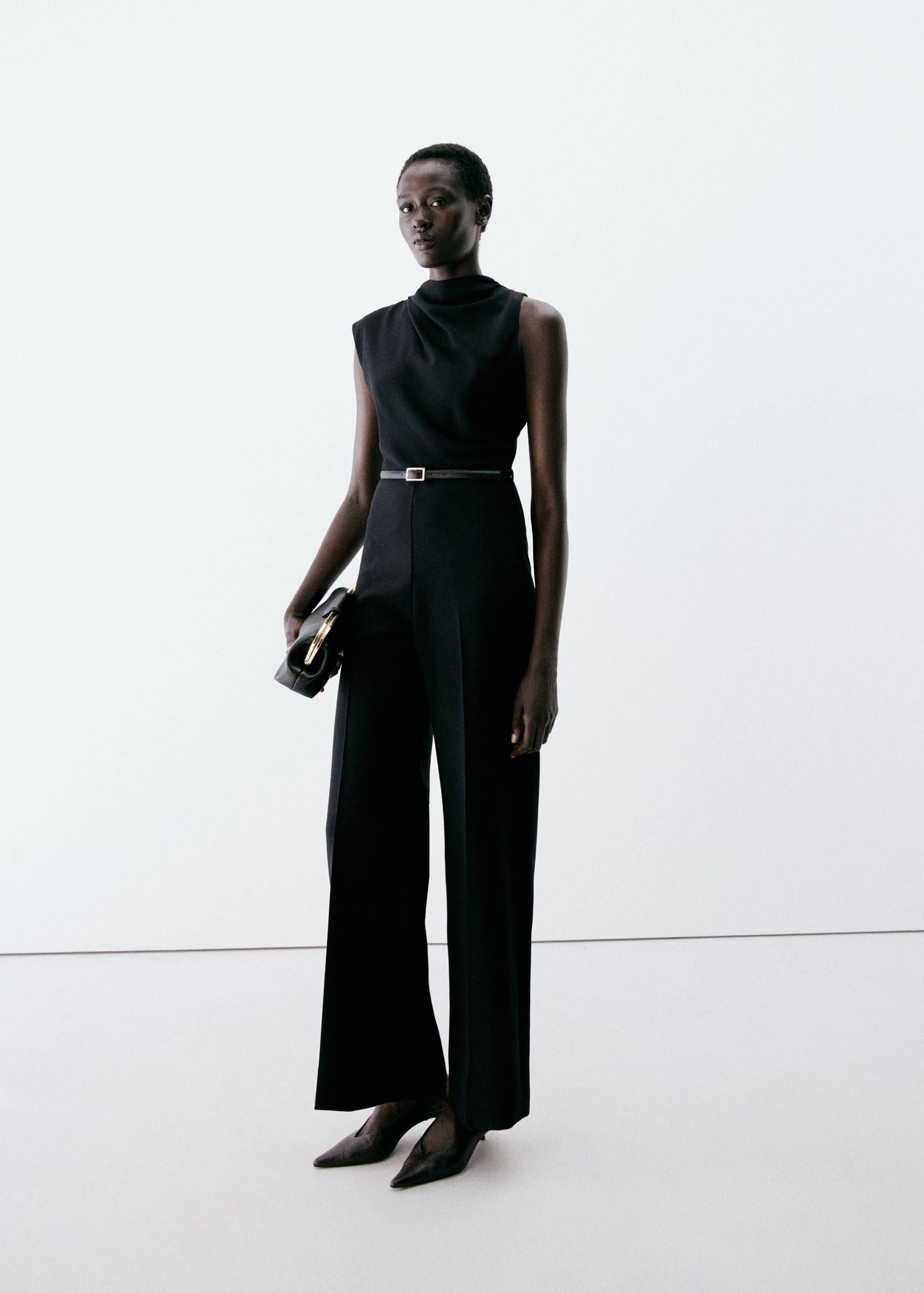 Black sleeveless jumpsuit with a draped cowl neck and wide legs.