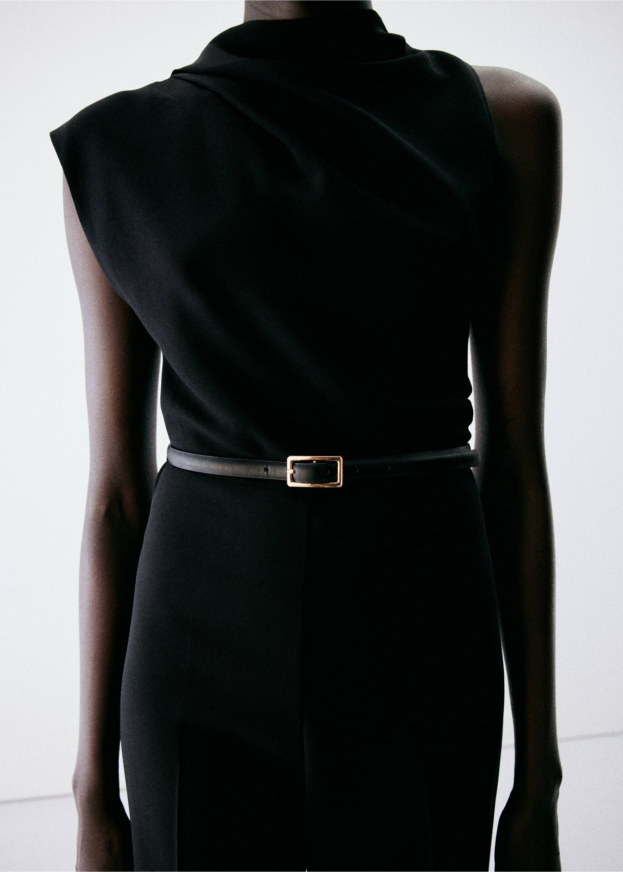 Black sleeveless jumpsuit with draped neckline and gold-buckle belt., Black. Ref: 37057806-00.