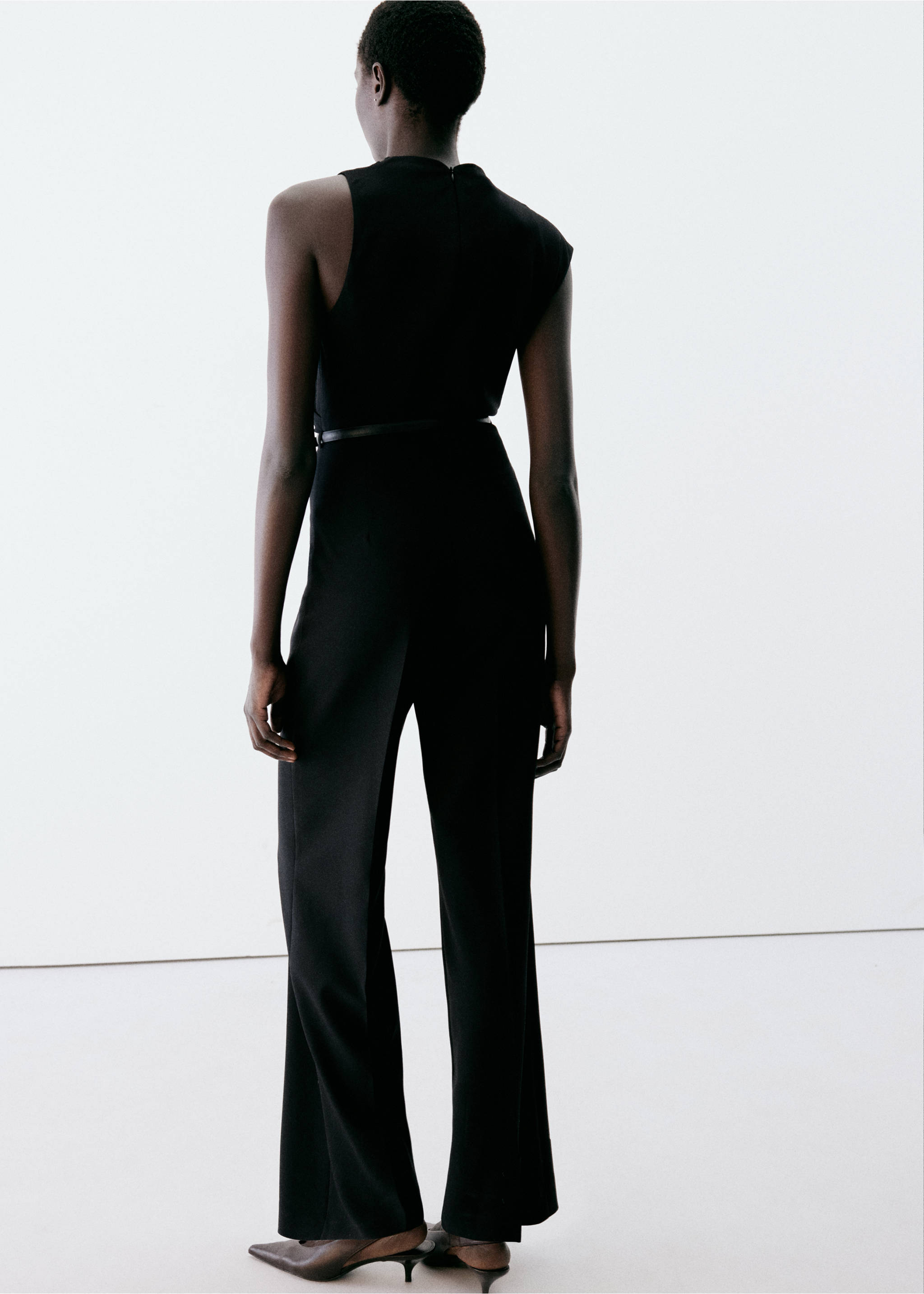 Back view of a sleeveless black jumpsuit with a thin waist belt., Black. Ref: 37057806-00.
