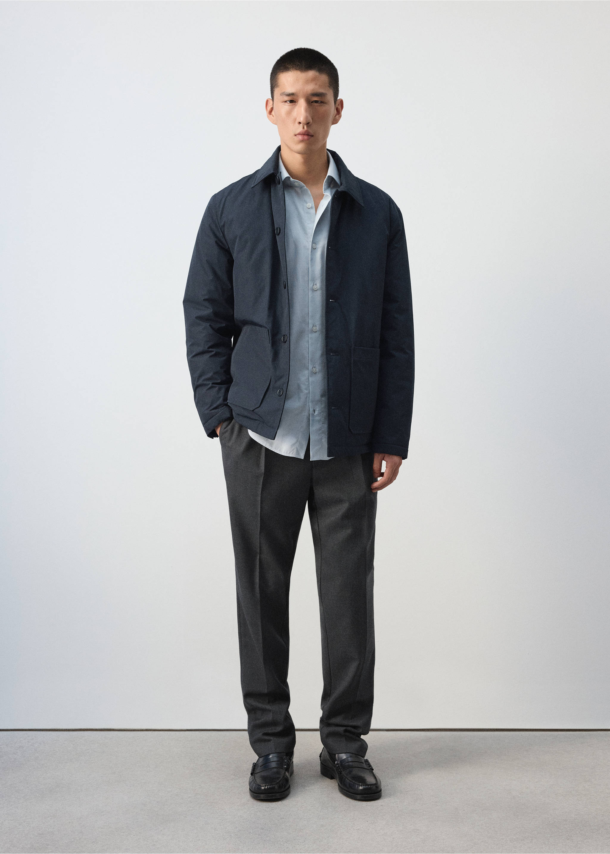 Dark navy blue jacket with a classic collar and front pockets, worn with a light shirt and grey trousers., Night Blue. Ref: 37057882-00.