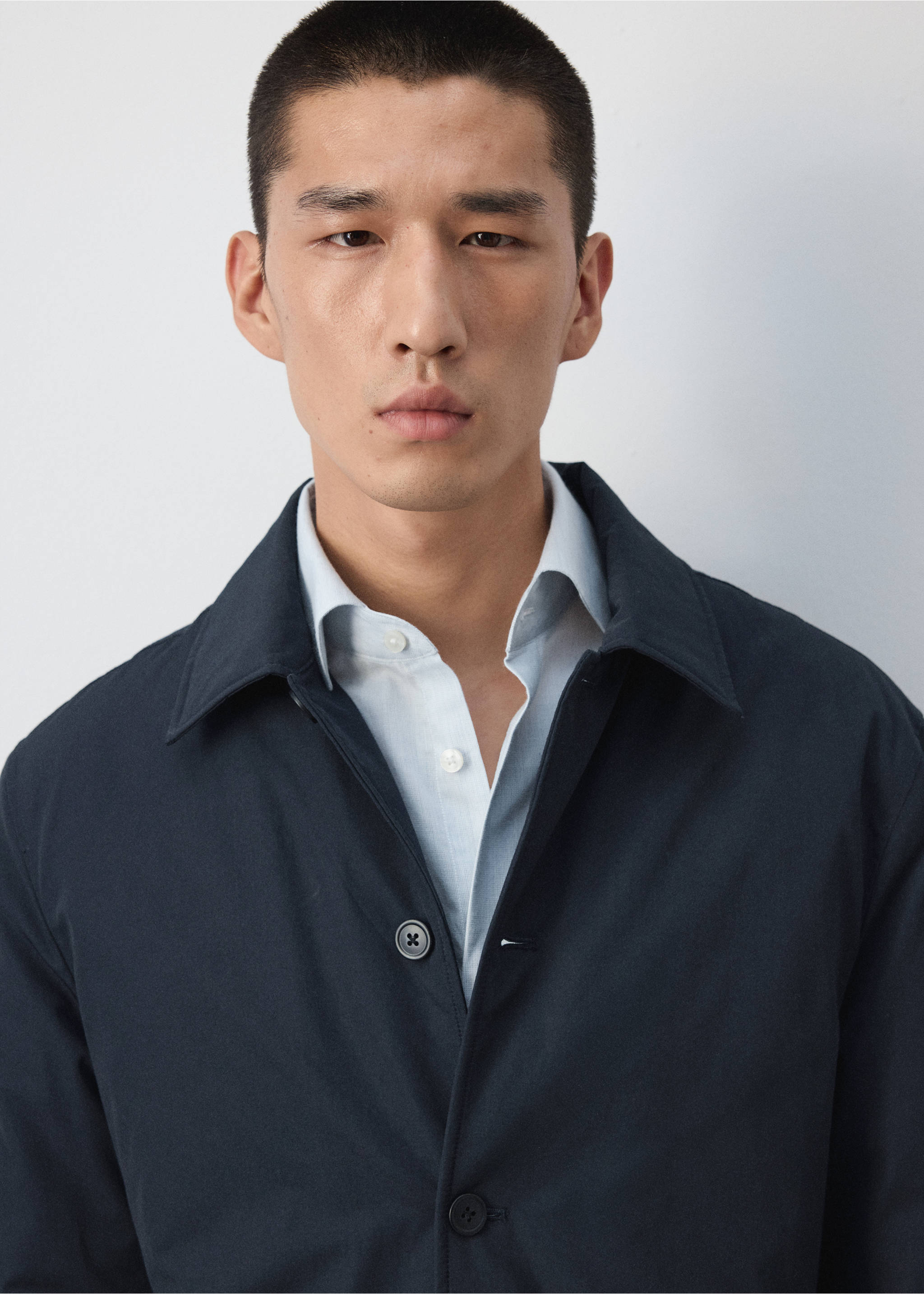 Close-up of a navy blue jacket worn with a light blue shirt., Night Blue. Ref: 37057882-00.