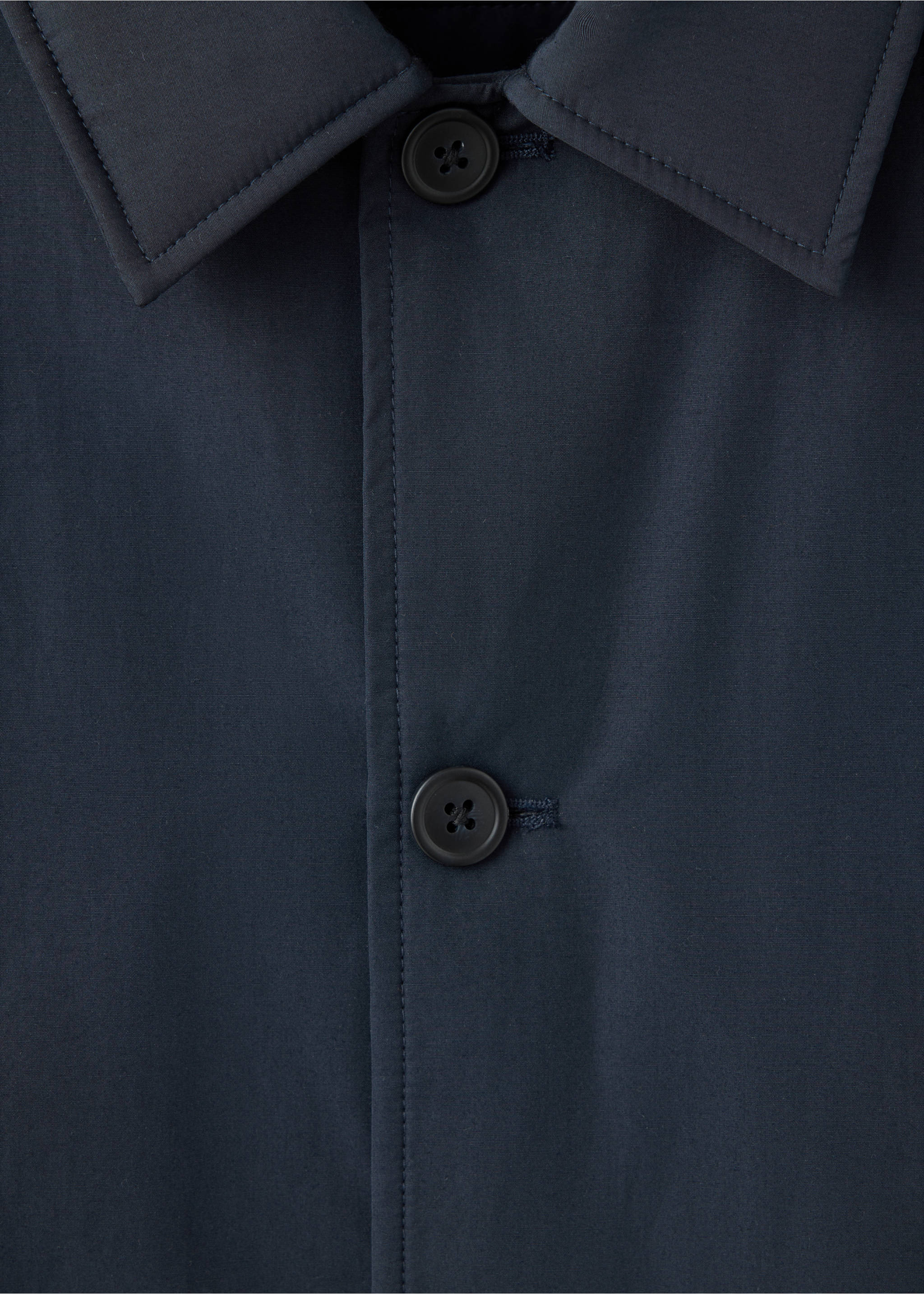 Close-up of a dark navy blue jacket collar and button placket detail., Night Blue. Ref: 37057882-00.