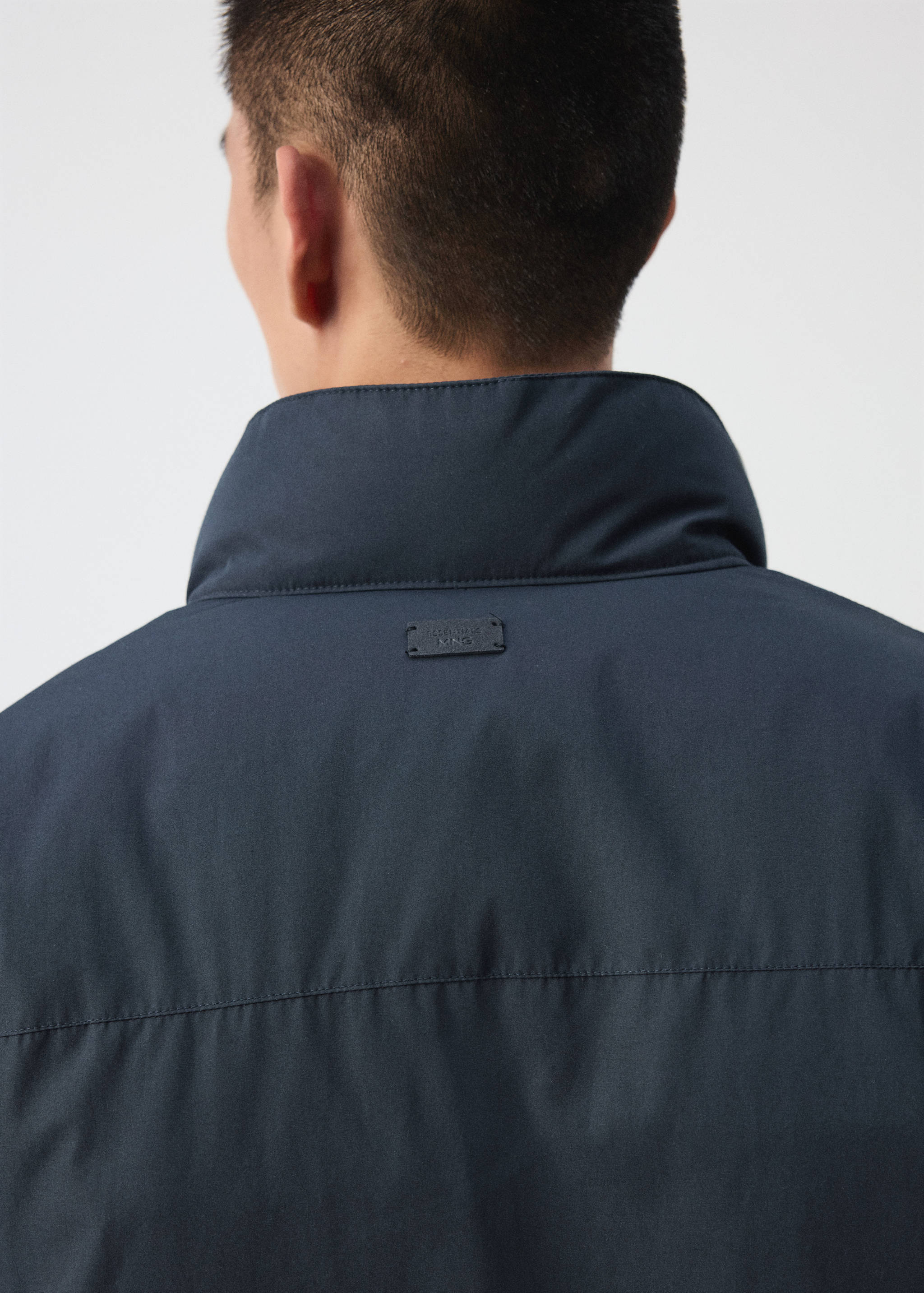 Dark navy blue jacket high collar, back view detail