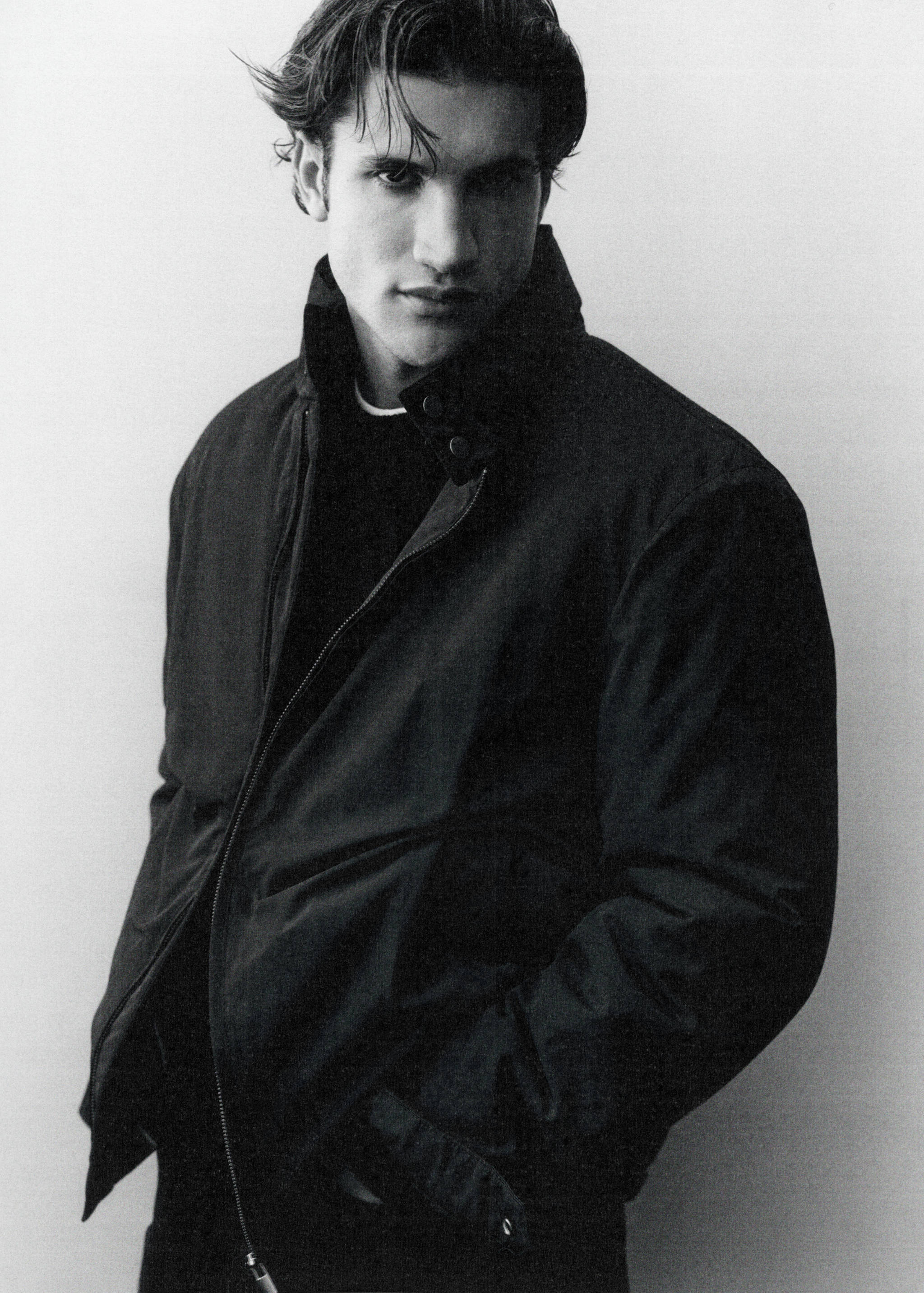 Black zip-up jacket with a high collar and snap buttons.