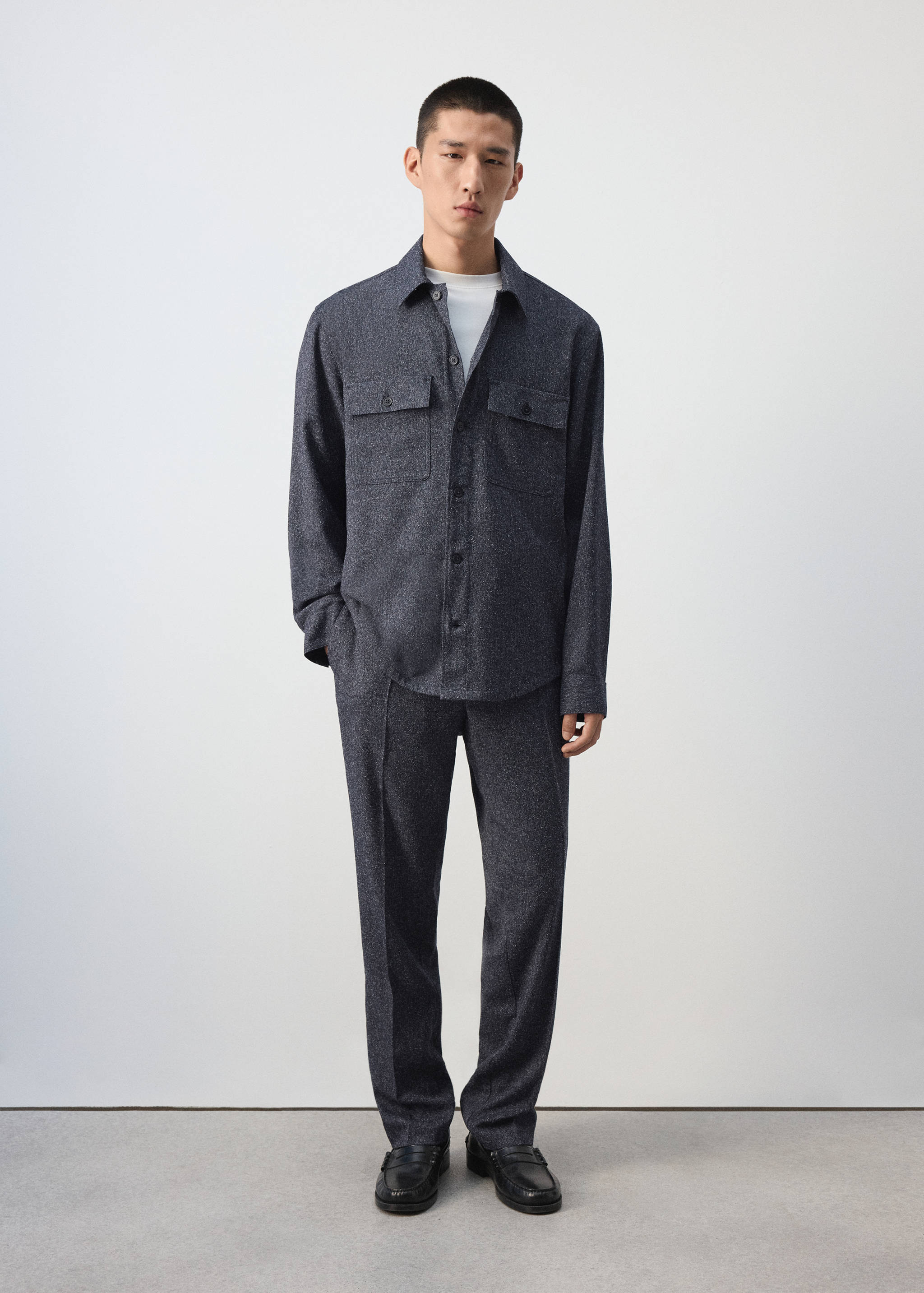Dark grey textured overshirt with chest pockets worn as part of a matching set.