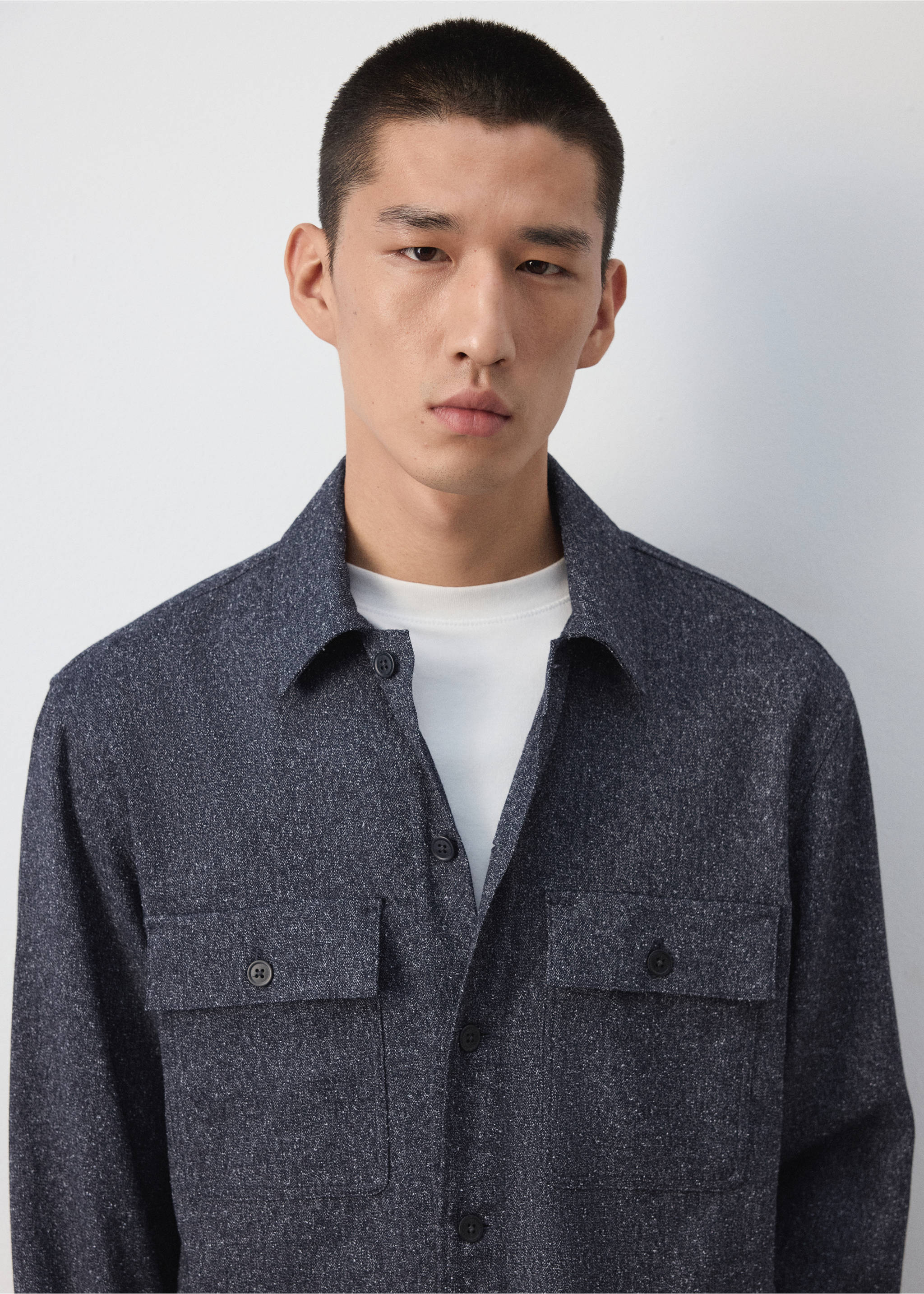 Navy blue speckled overshirt with chest pockets worn over a white t-shirt., Blue. Ref: 37057885-00.