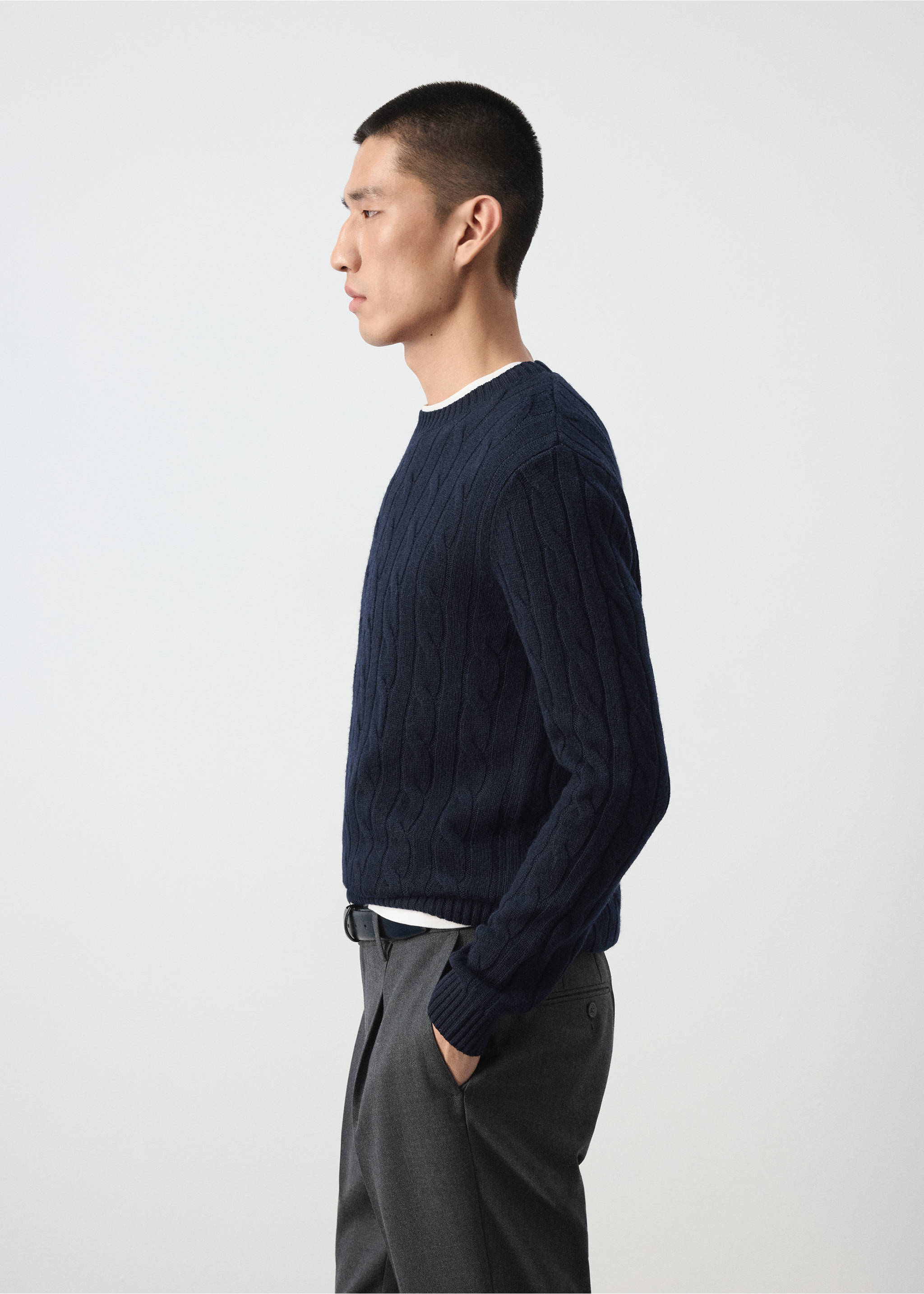 Navy blue cable-knit crew-neck jumper in a side profile view., Navy. Ref: 37057886-00.