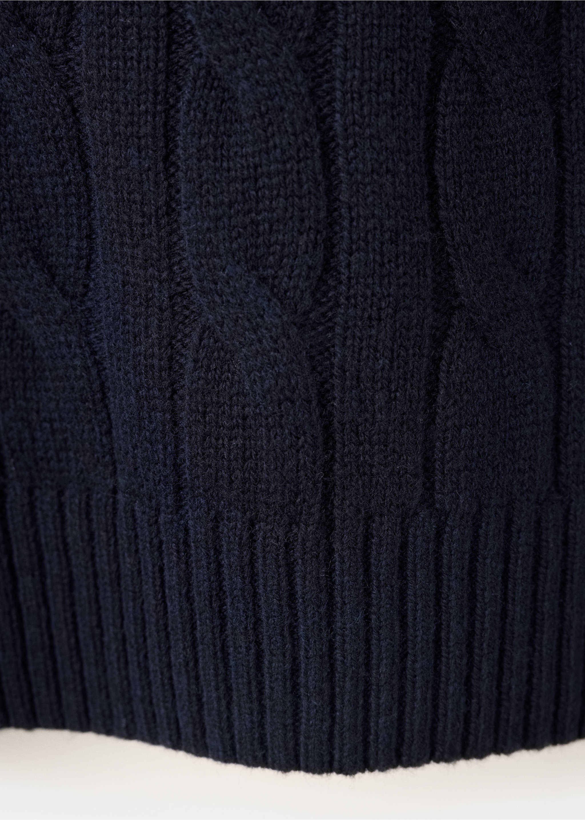 Close-up of navy blue men's cable-knit sweater fabric., Navy. Ref: 37057886-00.