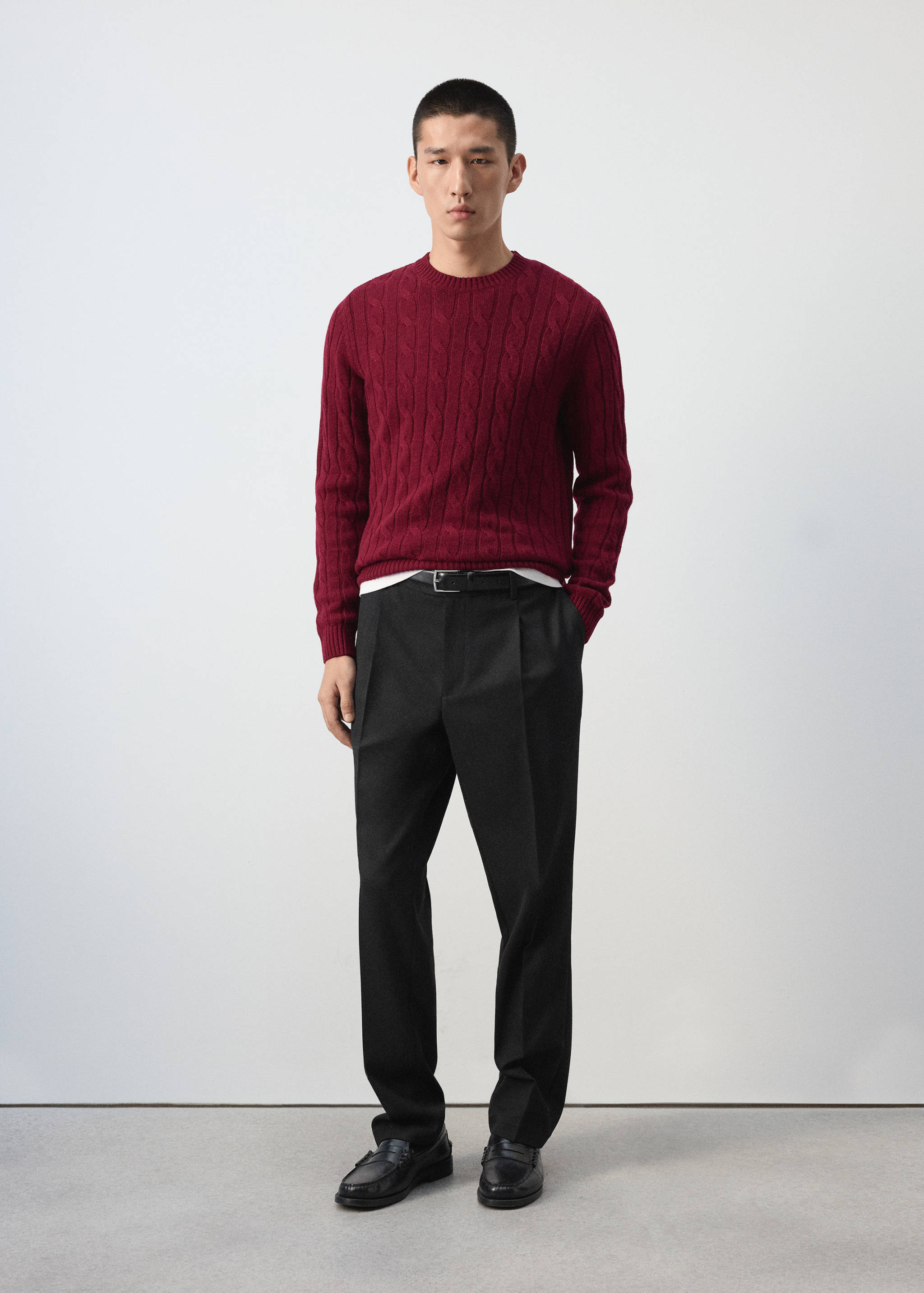 Burgundy cable-knit crew neck jersey with dark trousers