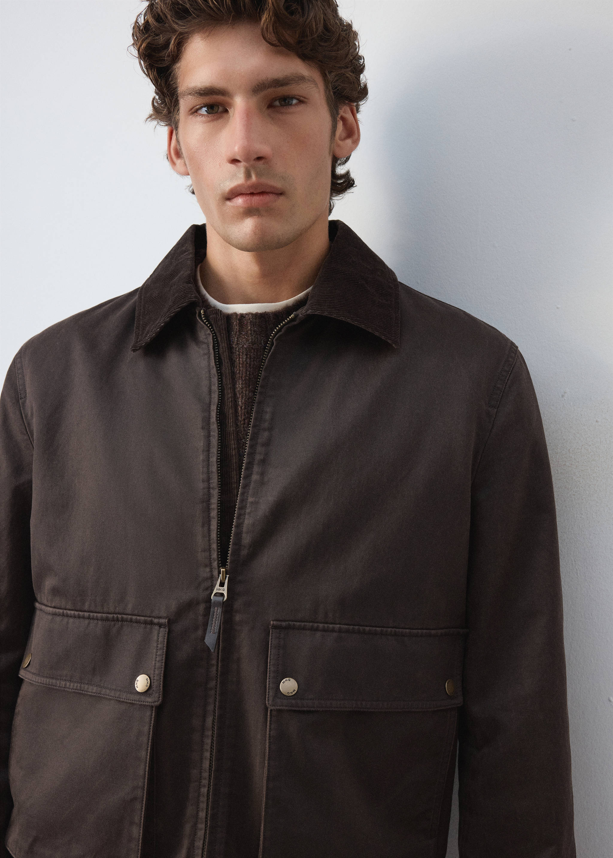 Dark brown zip-up jacket with a corduroy collar and front pockets.