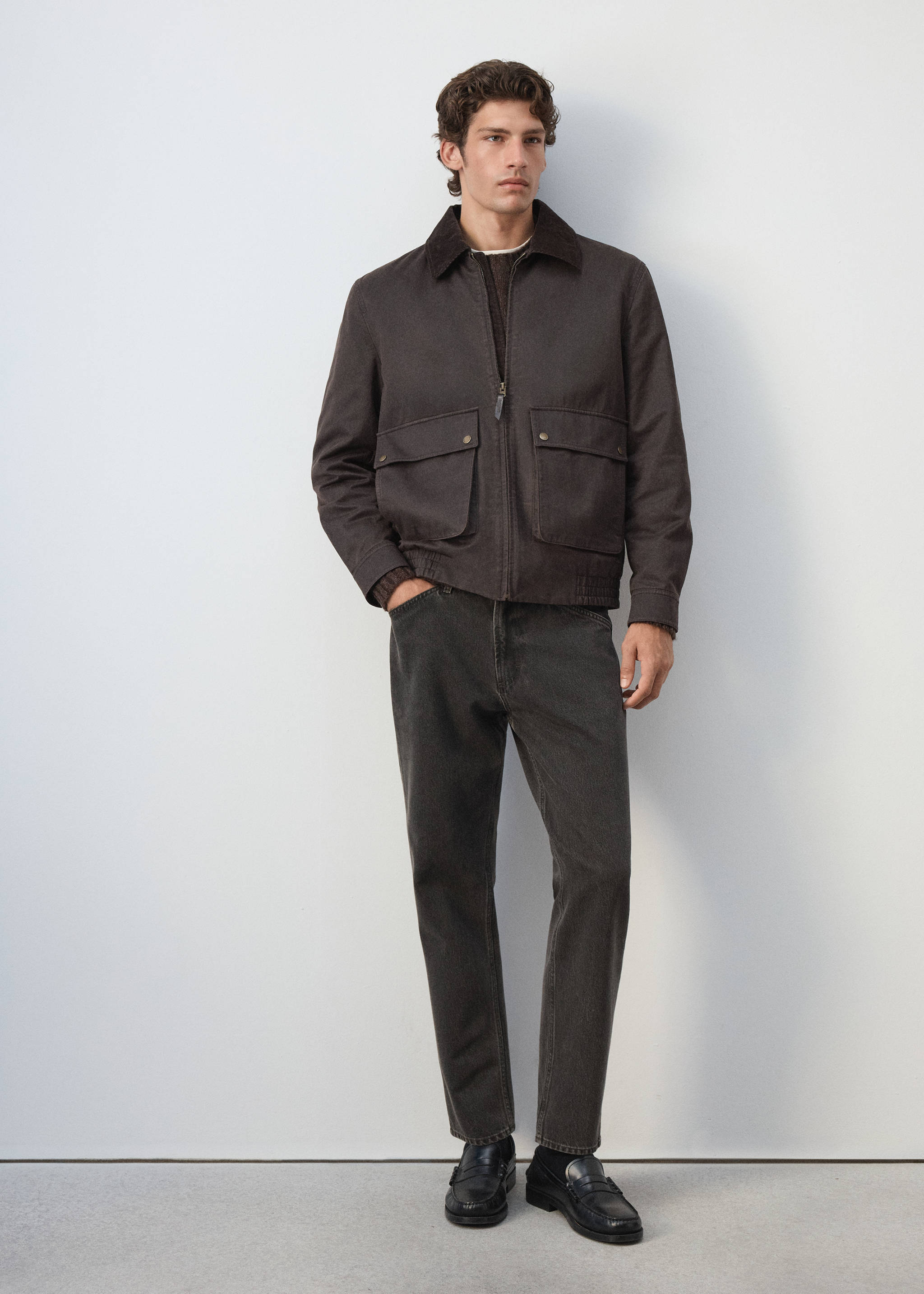 Dark brown jacket with corduroy collar and front flap pockets.