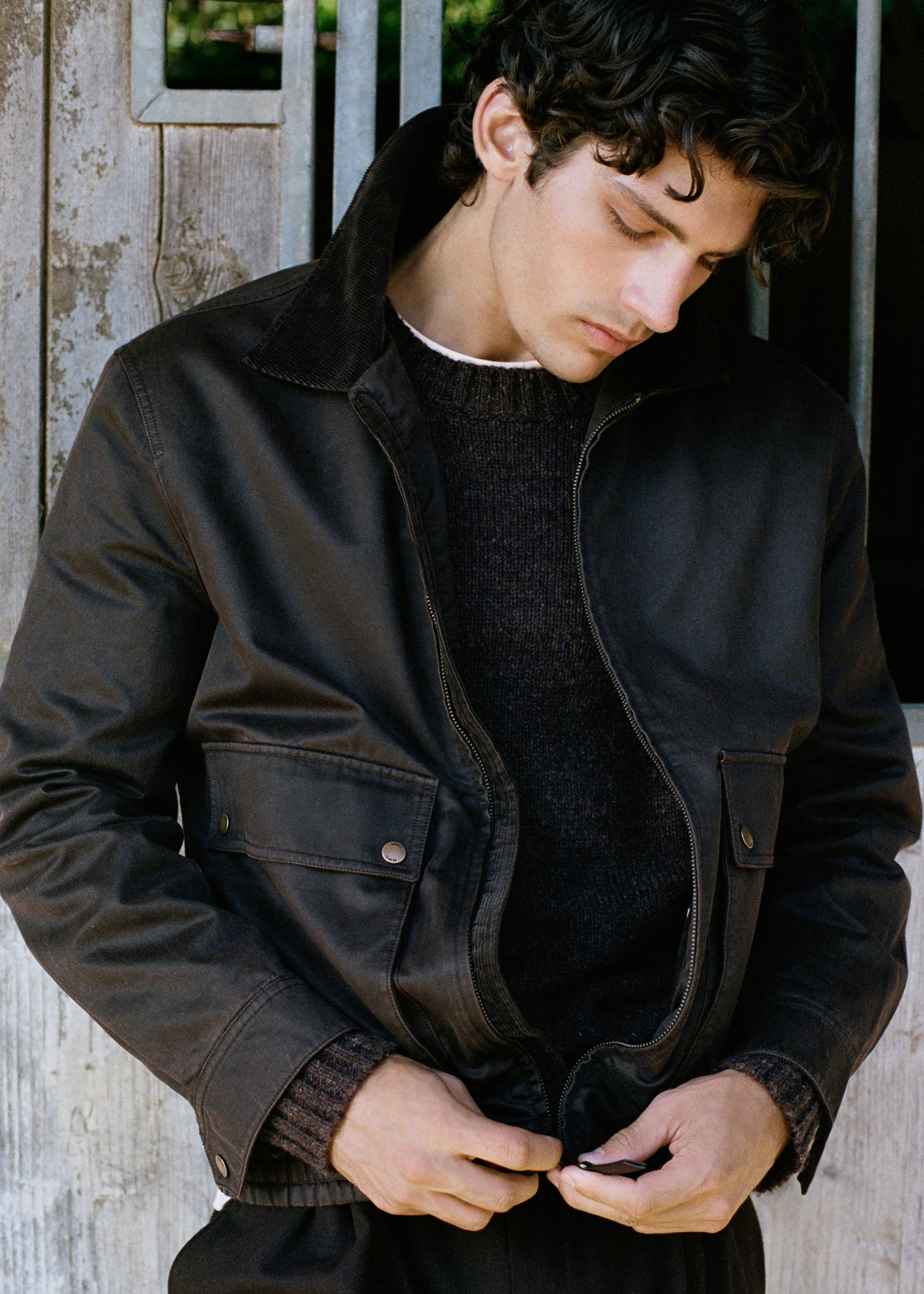 Dark brown jacket with corduroy collar and front flap pockets.