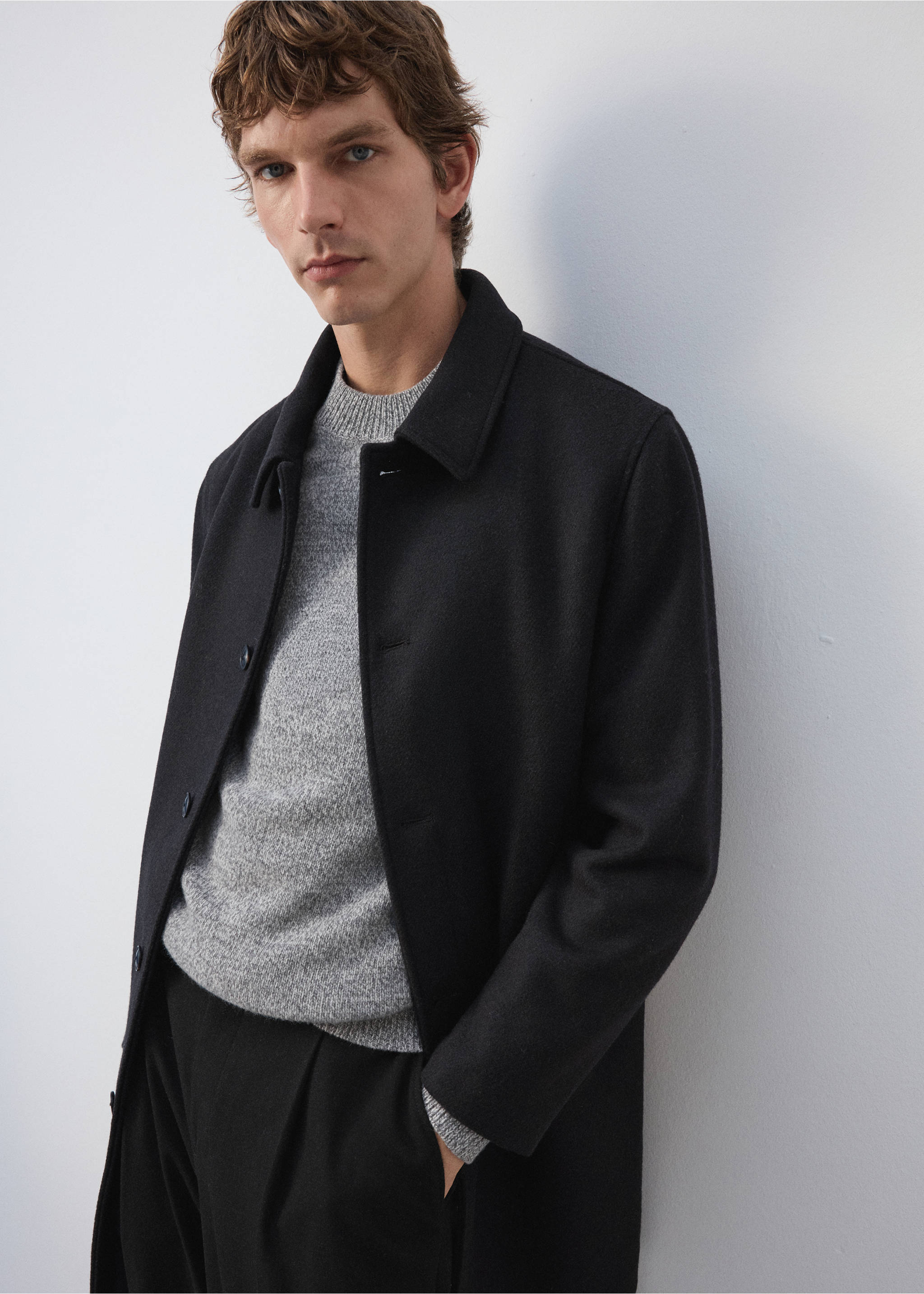 Black coat with a classic collar, worn over a grey knit sweater., Coffee. Ref: 37057888-00.