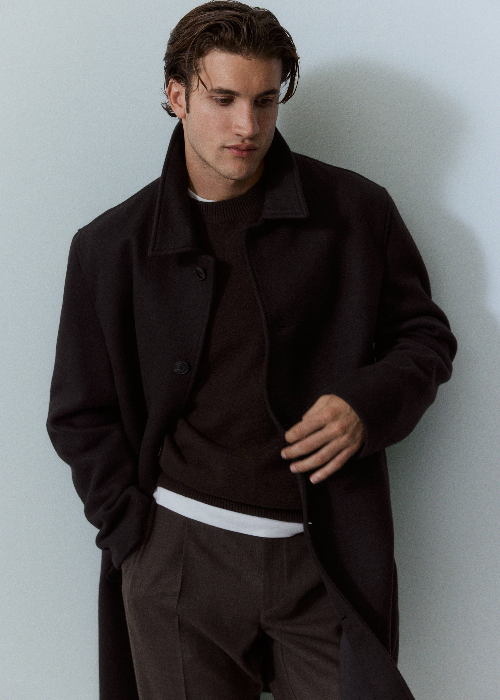Dark brown coat with a large pointed collar and front buttons.