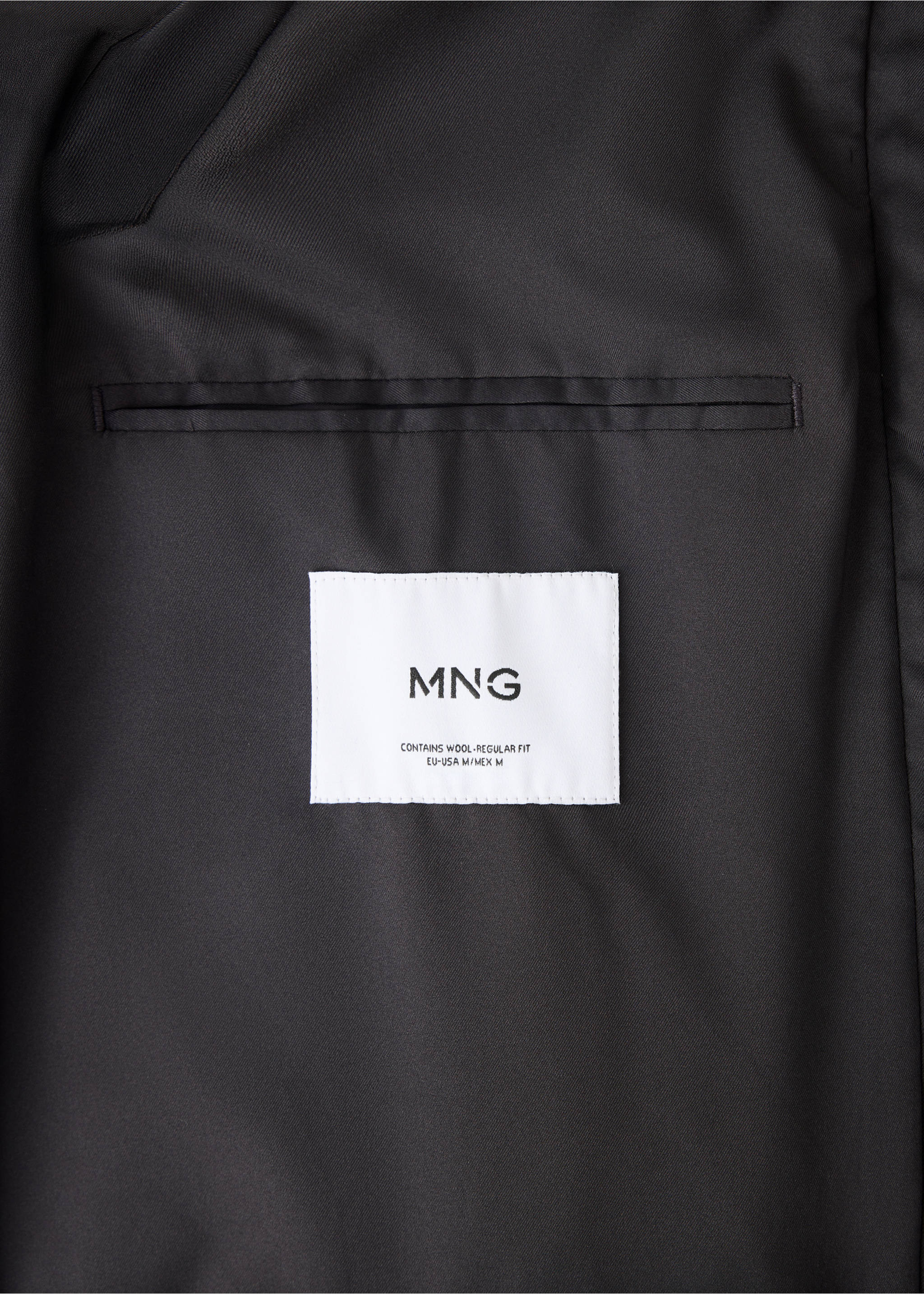 Close-up of the inner label and lining of a black coat., Coffee. Ref: 37057888-00.